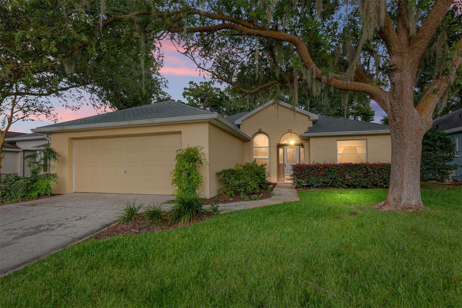 Welcome to this spacious modified Doral model located in the highly desirable Oak Run 55+ community. This well-designed home features a split-bedroom floor plan with 2 bedrooms, 2 bathrooms, and a versatile den that can easily be converted into a third bedroom, home office, or hobby room. The formal living and dining rooms showcase elegant coffered ceilings, creating an elegant and inviting space for entertaining. The kitchen is conveniently situated next to the indoor laundry room, which also connects directly to the primary bathroom for added convenience. Step outside to the impressive 25' x 14' screened birdcage, offering plenty of room for outdoor dining, relaxing, or entertaining while enjoying Florida's beautiful weather. Additional highlights include a central vacuum system, a 2022 roof, and an attached two-car garage. Situated on a maintained lot, the monthly service fee includes lawn mowing, edging, irrigation, and lawn pest control, providing a truly low-maintenance lifestyle.