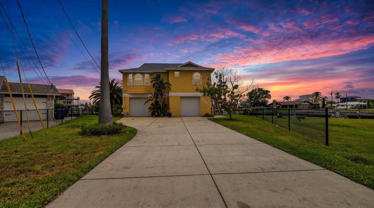 COASTAL LIVING AT ITS FINEST! Welcome to this beautifully UPDATED ELEVATED WATERFRONT HOME with DIRECT GULF ACCESS, perfectly positioned on an OVERSIZED CORNER LOT in one of Hernando Beach's most desirable CUL-DE-SAC locations. Boasting 147 FEET OF SEAWALL, expansive canal frontage, and a REAR WESTERN EXPOSURE for breathtaking Florida sunsets, this exceptional property delivers the ultimate waterfront lifestyle for boaters, anglers, kayakers, and nature lovers alike.
The oversized driveway provides ample space for your BOAT, RV, TRAILERS, GOLF CARTS, AND GUEST PARKING, while the oversized 2-CAR GARAGE offers abundant storage for all your coastal gear. The spacious backyard offers ROOM FOR A CUSTOM POOL and the perfect setting for outdoor entertaining or relaxing while enjoying peaceful water views and frequent wildlife sightings including dolphins and manatees.
The 1347 SF air condioned upper level has 3 bedroom and 2 bathrooms as well as a bright OPEN-CONCEPT GREAT ROOM featuring SOARING VAULTED CEILINGS, abundant natural light, and NEW LUXURY VINYL PLANK FLOORING throughout the main living area. The COMPLETELY RENOVATED KITCHEN is the centerpiece of the home with GRANITE COUNTERTOPS, WHITE SHAKER CABINETRY WITH CROWN MOLDING, STAINLESS STEEL APPLIANCES, a large breakfast bar, and seamless flow into the dining and living areas--ideal for entertaining.
Large BAY WINDOWS and SLIDING GLASS DOORS showcase stunning waterfront views and open to the SCREENED LANAI, creating effortless indoor-outdoor living perfect for enjoying morning coffee, evening cocktails, and Florida sunsets.
The primary suite features private lanai access, a WALK-IN CLOSET, and an ENSUITE BATH with a new DOUBLE-SINK VANITY and WALK-IN TILED SHOWER. The SPLIT FLOOR PLAN offers two additional guest bedrooms on the far end of the home, including one with a charming bay window and built-in bench. The guest bathroom has a tiled tub/shower combo with a NEW VANITY. Upstairs laundry with front-loading washer and dryer adds convenience.
The lower level offers a 2 car garage as well as an additional 600SF of AIR-CONDITIONED space that can be utilized as additional flex space including a FULL BATHROOM, KITCHENETTE, and multiple FLEX AREAS ideal for a HOME OFFICE, MEDIA ROOM, GAME ROOM, FITNESS ROOM, GUEST SUITE, OR ENTERTAINING SPACE. Sliding glass doors lead to a covered waterfront patio and direct access to the backyard, seawall, and FLOATING DOCK.
This property offers very reasonable HOMEOWNERS INSURANCE of 2,578 dollars per year for an owner occupant and new FLOOD INSURANCE of APPROX. 2,827 dollars per year. 
Located in the sought-after waterfront community of HERNANDO BEACH, this home offers QUICK DIRECT GULF ACCESS for boating, fishing, scalloping, kayaking, paddleboarding, and endless waterfront recreation. Hernando Beach is a vibrant coastal community known for its relaxed Florida lifestyle with GOLF CART ACCESS, NO HOA, NO DEED RESTRICTIONS, and SHORT-TERM RENTALS ALLOWED, making it ideal for full-time residents, snowbirds, and investors alike. Convenient access to marinas, waterfront dining, tiki bars, shopping, hospitals, top-rated schools, Weeki Wachee Springs, and the Suncoast Parkway provides easy commuting to Tampa and surrounding areas.