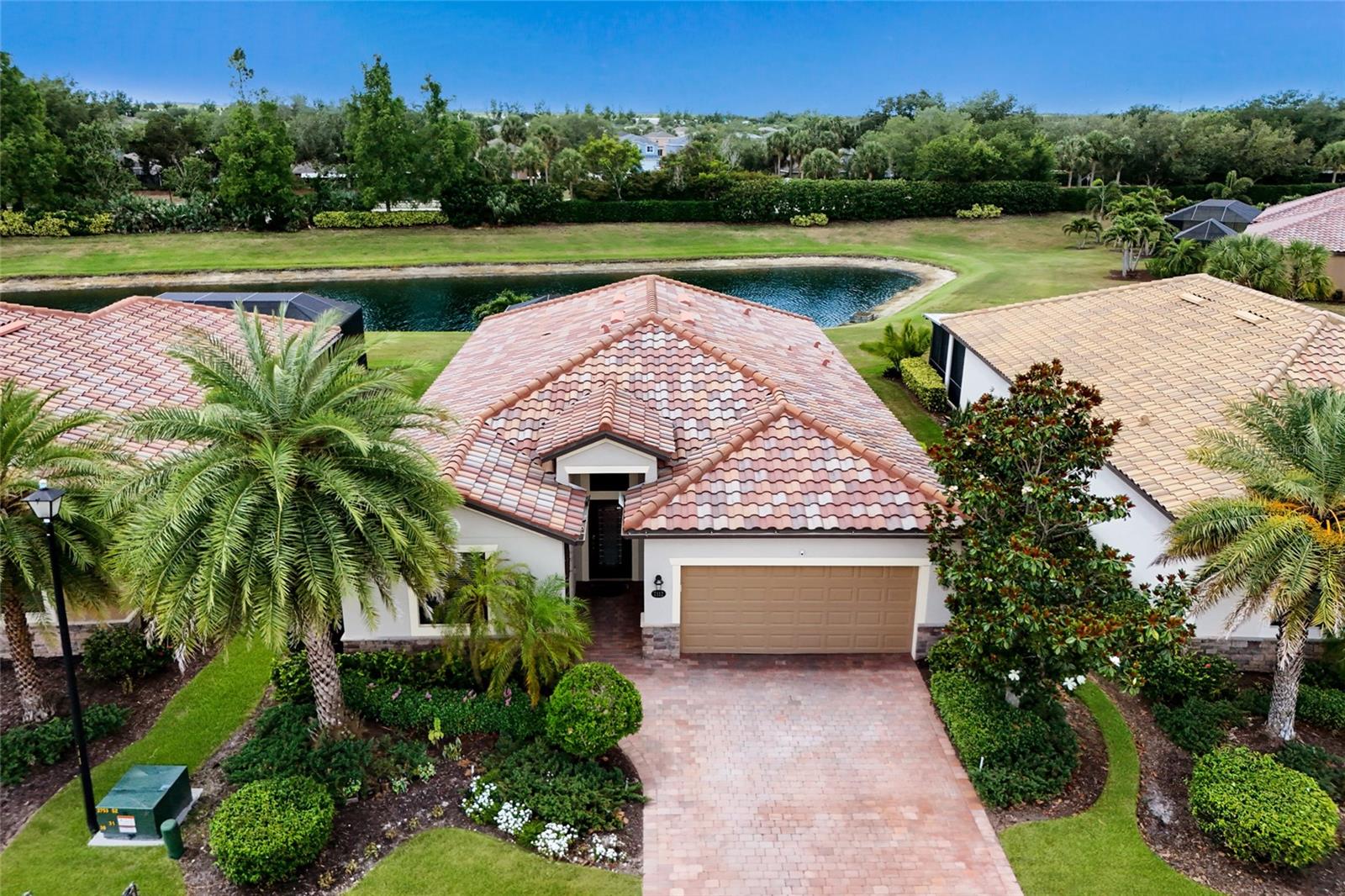 Located in the Sanctuary of River Strand at Heritage Harbour, this beautifully maintained 4-bedroom, 3-bath home offers over 2,000 square feet of updated living space, peaceful pond views, and the ease of maintenance-free living within one of Bradenton’s most amenity-rich communities. Tucked away on a quiet cul-de-sac street, this home combines privacy, modern updates, and resort-style living just minutes from everyday conveniences. In addition to access to an incredible lineup of amenities, the HOA fee includes lawn and sprinkler maintenance, cable, and high-speed internet, creating added value and convenience. Thoughtfully refreshed with updates throughout, the home features luxury vinyl plank flooring in all bedrooms, fresh interior paint (2022), fresh exterior paint (2024), a newer refrigerator (2022), and washer and dryer (2023). Crown molding throughout adds an elevated touch, while the bright open layout creates an easy flow designed for both everyday living and entertaining. At the center of the home, the kitchen has been updated with a stylish backsplash, designer lighting, and a custom island accent wall. Opening seamlessly to the main living and dining spaces, the layout creates an inviting setting for gatherings large and small. The spacious primary suite offers a comfortable retreat with dual walk-in closets featuring custom built-in shelving, while three additional bedrooms and two full bathrooms provide flexibility for family and guests. Step outside to the extended paver lanai overlooking tranquil pond views, creating the perfect setting for morning coffee or evenings outdoors. The backyard also offers room to add a pool if desired. River Strand delivers a true resort-style lifestyle. Residents enjoy a beautiful clubhouse with a newly renovated restaurant and bar, expanded outdoor dining spaces, a state-of-the-art fitness center with a variety of classes, 2 main resort-style pools and spas, six additional satellite pools, a resistance pool, 9 Har-Tru tennis courts, 8 pickleball courts, and a dedicated Racquet Sports Pro Shop with certified instructors. Golf enthusiasts will appreciate the 27-hole championship course with pay-as-you-play access. Perfectly positioned near the new Bradenton Marketplace with Target, Costco, Hobby Lobby, ALDI, dining, and shopping and offering easy access to I-75, UTC, Lakewood Ranch, and Sarasota, this home combines peaceful community living with convenient access to everything the area has to offer.