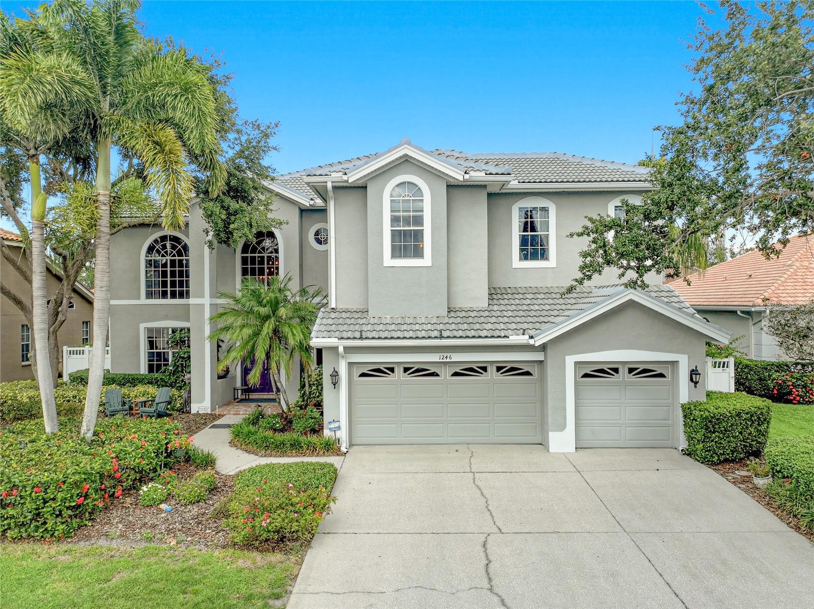 Behind the gates of Placido Bayou, where tree-lined streets, friendly neighbors, and daily walks become part of your routine, this 3,770-square-foot residence offers a lifestyle that feels both elevated and effortless. Just minutes from vibrant downtown St. Petersburg, it's a place where privacy and connection exist in perfect balance. The arrival sets the tone. A grand entry framed by soaring two-story windows and an elegant staircase welcomes you inside, filling the home with natural light and creating an immediate sense of openness. Every space has been thoughtfully designed for both quiet moments and unforgettable gatherings, with formal living areas that transition seamlessly into comfortable everyday spaces. At the heart of the home, the beautifully renovated kitchen has been reimagined with timeless finishes and exceptional functionality. Quartz countertops, an oversized island, gas cooktop, walk-in pantry, antique brick backsplash, and spacious dining area make it equally suited for holiday dinners and casual breakfasts. Offering five bedrooms and four-and-a-half baths, the home provides remarkable flexibility, with one downstairs bedroom currently serving as a dedicated office. Upstairs, an expansive bonus room offers endless possibilities as a media room, playroom, fitness studio, or second family room. One guest suite enjoys its own attached bath, creating a comfortable retreat for visitors. The primary suite feels like a luxury hotel suite. Spacious and serene, it opens onto a large private balcony overlooking the backyard, creating the perfect setting for morning coffee or an evening under the stars. The spa-inspired bath transforms daily routines into moments of indulgence, featuring a soaking tub, dual sinks, dedicated vanity, and oversized walk-in shower with personalized Moen Smart Controls, operational by app or voice control and set to your preferred water temperature at the touch of a button. Two walk-in closets are the cherry on top. Functionality is equally well considered. The downstairs laundry room, serviced by an upstairs laundry chute, offers generous storage and workspace, while the three-car garage includes an electric vehicle charger. Outside, Florida living takes center stage. The two-story screened enclosure frames a sparkling pool surrounded by an expansive paver deck with abundant room for lounging, dining, and entertaining. Whether hosting friends or enjoying a quiet afternoon in the sun, the outdoor spaces feel as intentional as those inside. Along the side of the home, a charming flower garden creates a hidden escape filled with color, texture, and seasonal blooms, a peaceful corner that feels almost magical. Other practical features include a new tile roof (2025), landscape lighting, remote-control gas fireplace, and no history of flooding. Beautifully updated, exceptionally spacious, and designed with equal attention to luxury and livability, this is more than a remarkable property. It's the backdrop for the next chapter of your story. All of this is just minutes from St. Petersburg's vibrant waterfront, renowned dining, boutique shopping, world-class arts, and year-round events. Award-winning beaches and airports are also a short drive away, while the Racquet Club of St. Petersburg sits at the entrance to the neighborhood, offering both pickleball and tennis. This is the perfect setting to embrace the effortless indoor-outdoor lifestyle that defines Florida living. Welcome home.