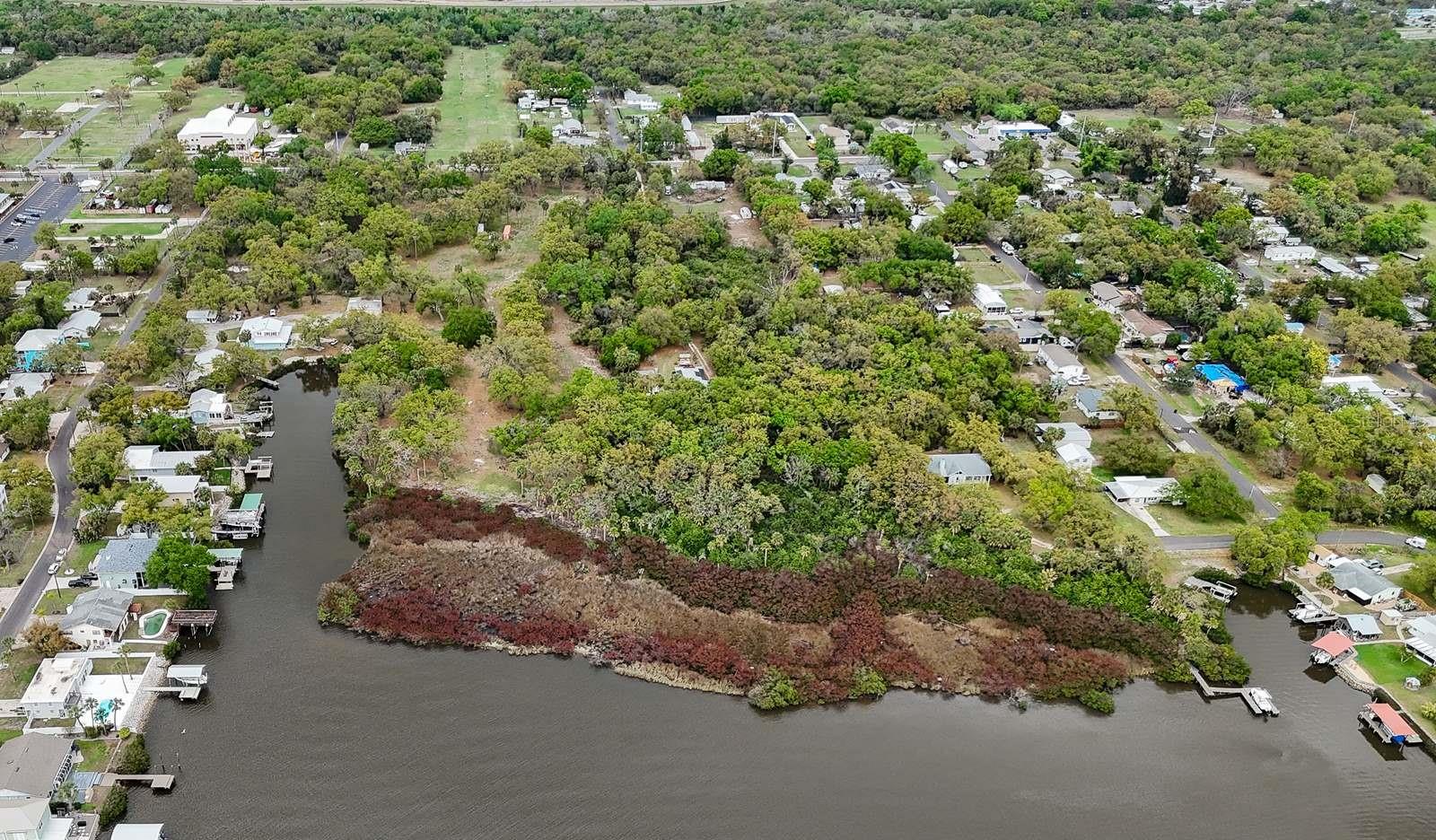 Prime 9.85-acre waterfront development site located at 7013 & 7015 Riverview Drive in Riverview, FL — one of the Tampa Bay region's fastest-growing corridors. The property features approximately 300 feet of direct Alafia River frontage along the southern boundary plus canal frontage along the western edge, offering a rare combination of scale and water access for a residential infill project. The site was previously entitled for a 45-unit single-family planned development (RZ 06-1721, approved February 2007) on a larger combined parcel. The owner subsequentially rezoned the property to Agriculture. The site is currently vacant and recently cleared, presenting a clean canvas for redevelopment. The highest and best use is believed to be a rezoning back to PD for single family residential - a path supported by the sites prior entitlement history and surrounding land use.  ±300’ riverfront plus canal frontage