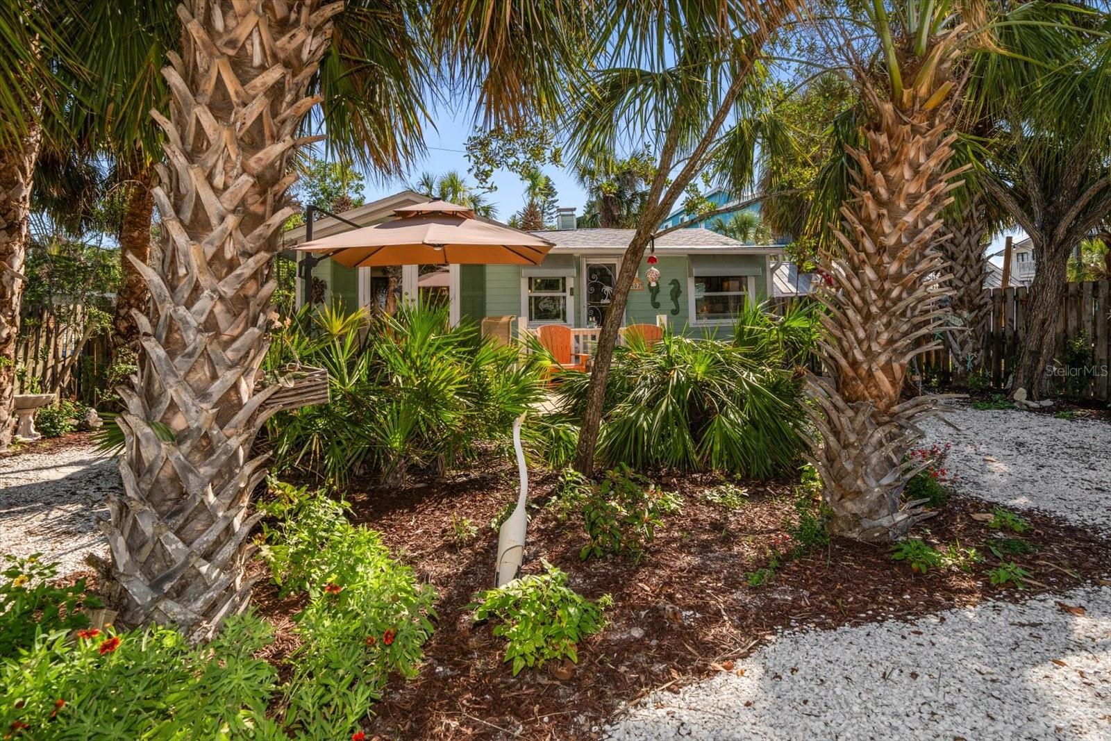 A signature Sunset Beach cottage, incredibly maintained by its long term owners is now available for purchase.  Located on the south end of Sunset Beach this pristine cottage is tucked away in the back of a large West Gulf Blvd lot, protected by a high elevation & Florida Native landscaping. Listen to the surf and enjoy Gulf & Sunset views from your front yard.  Upon entering you will find character & charm in every corner. Decorative ceilings, wood walls, gas stove & fireplace & real Oak floors are just a few key features. Located directly across the street from the locals’ beach access.  This cottage weathered Hurricane Helene with 3 inches of rising water in the lower level Only, due to it’s elevation, solid construction, impact windows, Hardie board siding & mature native landscaping. The spacious deck was built by one of the area’s premiere dock builders.  This picturesque hidden oasis on The Boulevard is not to be missed.  Enjoy this vintage beach cottage until you are ready to build on this premier oversized lot which would provide both Gulf & Intracoastal views, directly across the street from the beach. Call for a home tour today. New AC in 2025.