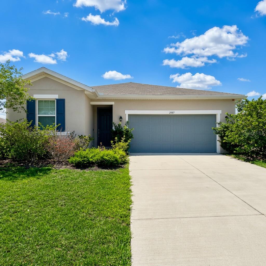 Welcome to 2587 Summer Star Way in the sought-after Seasons at Hillside community! This beautiful 3-bedroom, 2-bath home features an open-concept layout, split-bedroom floor plan, spacious living areas, and an oversized lot with mature landscaping. The kitchen offers GE stainless steel appliances, a natural gas range, MasterBrand oak cabinets with 36" uppers, and ample storage. Energy-efficient features include natural gas heating and R-38 ceiling insulation. Enjoy Florida living with double sliding glass doors leading to a covered lanai, perfect for relaxing or entertaining. The extended driveway provides plenty of parking space. Conveniently located just minutes from Downtown Leesburg, Venetian Gardens, Lake Harris, Ski Beach & Grill, shopping, dining, and major roadways. Ask about available Down Payment Assistance programs for qualified buyers. Don't miss this move-in-ready opportunity!