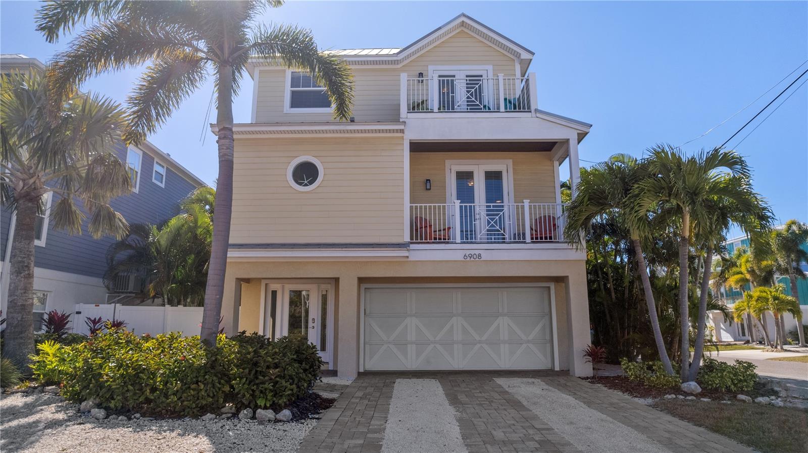 Welcome to Sands of Time, a recently updated six-bedroom, four-and-a-half-bathroom coastal retreat located less than two blocks from the white-sand beaches in the heart of Holmes Beach on Anna Maria Island. Thoughtfully designed and professionally decorated, this home blends relaxed beach style with upscale comfort, making it ideal as a primary residence, second home, or high-performing investment property.

Inside, the spacious layout comfortably accommodates family and guests, with multiple living areas and a fully equipped kitchen designed for entertaining and everyday living alike. High-capacity laundry is conveniently located on the main floor, perfect after long days at the beach. Four private balconies invite you to enjoy morning coffee or evening breezes, while the home’s open flow creates a welcoming atmosphere throughout.

The outdoor living space is a true highlight. A private heated pool and spa with a waterslide anchor a beautifully updated backyard featuring a bar with seating, lounge chairs, a large outdoor dining area, an outdoor shower, and a stainless-steel grill. A covered lanai beside the pool offers ample seating and an outdoor television, making it an ideal gathering place day or night. As evening falls, the backyard transforms into a tropical oasis with illuminated palms and ambient lighting.

Entertainment continues indoors and in the oversized garage, which has been converted into a game space complete with a ping pong table, foosball table, and arcade game. When it’s time to unwind, the home offers six well-appointed bedrooms, each with a flat-screen television. Four bedrooms feature king beds, including three with en suite bathrooms and private balconies. One bedroom includes two twin beds, while another offers two sets of bunk beds, creating a perfect space for kids or guests. A half bath is located on the main floor, with an additional full bathroom upstairs.

Situated on a quiet stretch of Holmes Boulevard, the property offers both privacy and convenience. Shops, restaurants, and island favorites along Pine Avenue are just minutes away, and the free island trolley stops nearby, providing easy access to all seven miles of Anna Maria Island. From boutique shopping and dining to fishing, boating, kayaking through mangroves, dolphin tours, and unforgettable sunsets, everything the island is known for is within easy reach.

Sands of Time delivers the best of island living with space, style, and an unbeatable location in the heart of Holmes Beach. Schedule your private showing today!