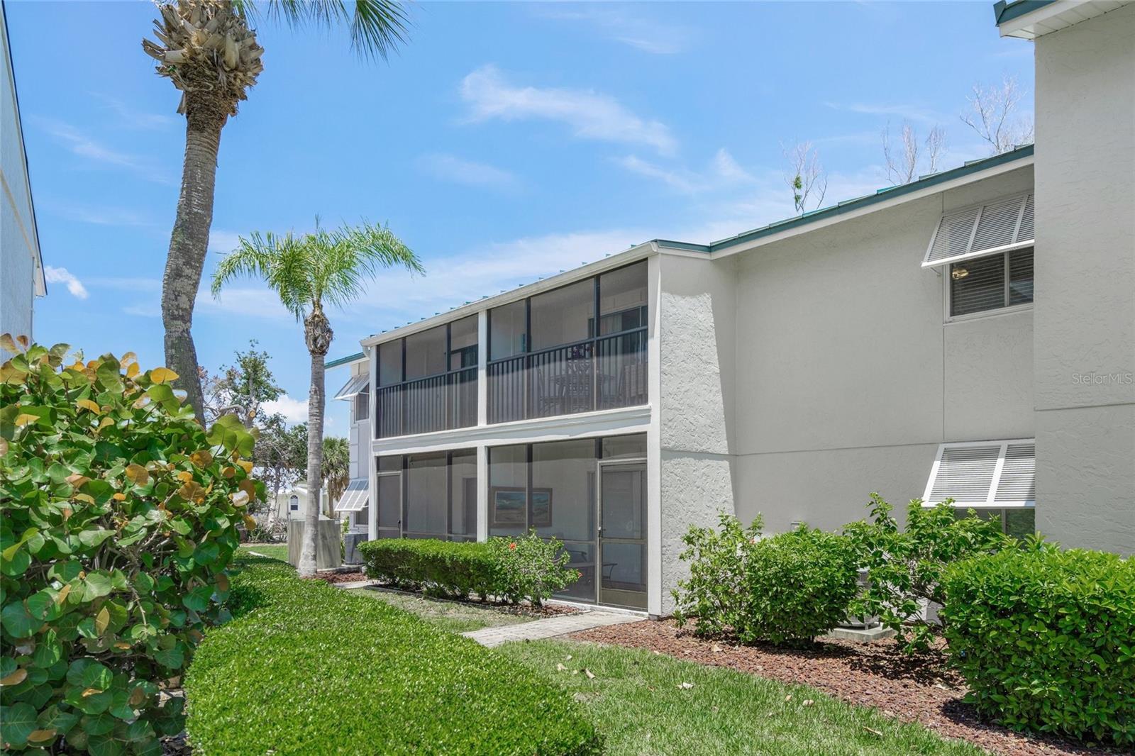 Welcome to your relaxation destination- White Sands Village- located across from Tripadvisor's #1 RATED BEACH IN THE U.S. AND #4 IN THE WORLD- SIESTA BEACH! Let the cool quartz white powder sand and clear water soothe your soul. This comfortable 1,012 sqft, TURN KEY FURNISHED, 2 bedroom/ 2 bath condo has recently been refreshed by a professional designer. The UPDATED, opened up kitchen features granite countertops, stainless steel appliances and a delightful window looking out to the lush tropical greenery. Entertain guests in the open plan dining and living room. The 2 spacious bedrooms offer multiple large closets and plenty of room to accommodate additional visitors. You'll love that the 2 bathrooms are updated with granite countertops and there is hard flooring throughout the condo. Enjoy sunsets and a peek-a-boo boat basin view while sipping your favorite cold beverage from the screened lanai. This 2nd floor unit is ideally positioned in the back of the complex in an end building providing privacy and tranquility with no one above you...and peace of mind with it being high and dry! The community features a charming clubhouse with sauna, heated pool, BBQ grills, picnic areas, boat docks available for rent annually on a first come first serve basis, multiple laundry facilities and designated parking spaces under shaded carports as well as plenty of open guest parking. Just across the street at the public beach you'll find tennis, pickleball, volleyball and a playground! Take the trolley to Siesta Village for delicious local restaurants, live music, farmers market, festivals, fitness and shopping. The flexible 2 week and pet friendly rental policy combined with the ON-SITE rental management office makes this an excellent investment opportunity that's easy breezy! Call today to schedule your private showing and start living the Florida dream!