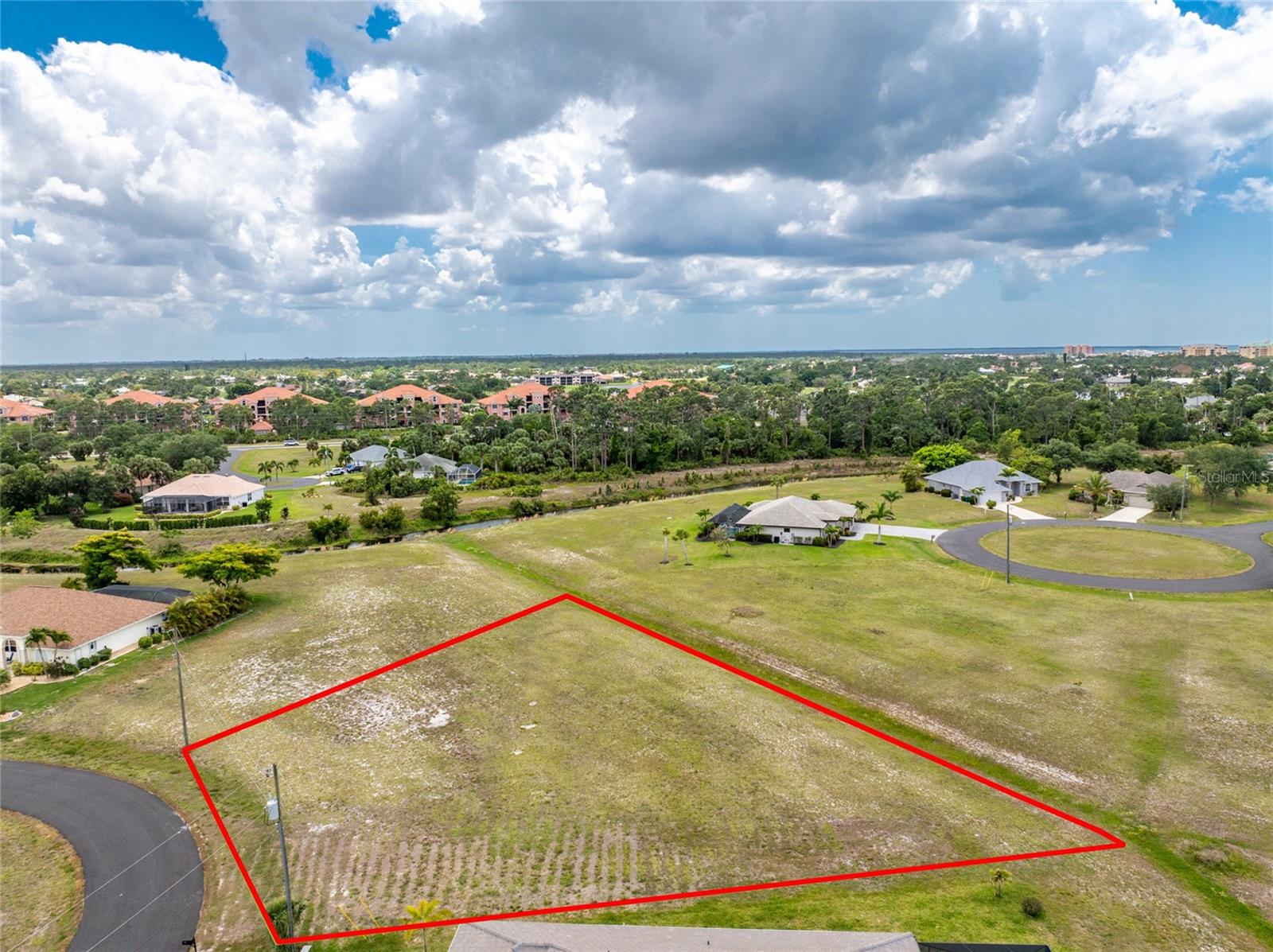 Don’t miss this fantastic opportunity to own two side-by-side parcels sold together, with the desired west/southwest rear exposure, in an X-500 flood zone, a combined .47 acres in the desirable, deed-restricted community of Burnt Store Lakes. This rare opportunity boasts impressive dimensions, including a deep 125-foot lot, 103 feet of frontage, and an expansive 221-foot rear border, providing the space and flexibility to design your ideal Florida retreat. An expansive community greenbelt behind the property adds valuable privacy and enhances the sense of openness, giving you a unique separation from neighboring homes. Located at the end of a quiet cul-de-sac, this setting offers peace, low traffic, and a true neighborhood feel. With public utilities already in place and the advantage of being in an X-flood zone, this property provides both convenience and cost-effective building potential. Burnt Store Lakes is one of Punta Gorda’s premier residential communities, known for its beautiful natural surroundings and friendly atmosphere. Residents enjoy scenic freshwater lakes throughout the community—perfect for kayaking, canoeing, and wildlife watching, walking and biking opportunities along peaceful streets, a large community park with pavilions, picnic areas, and a kayak/canoe launch directly into Charlotte Harbor. Adjacent to Burnt Store Marina, offering world-class boating, 27-hole golf, waterfront dining, and a variety of social activities just minutes away. Easy access to Punta Gorda, Cape Coral, and Fort Myers, along with shopping, restaurants, parks, medical facilities, and the Punta Gorda or Southwest Florida Regional Airports. Whether you envision building a spacious custom home, creating a multi-parcel estate, or securing a valuable land investment, this unique .47 acre offering provides unmatched space, location, and lifestyle. Experience the tranquility, natural beauty, and exceptional convenience of living in Burnt Store Lakes—where your Florida dream begins.