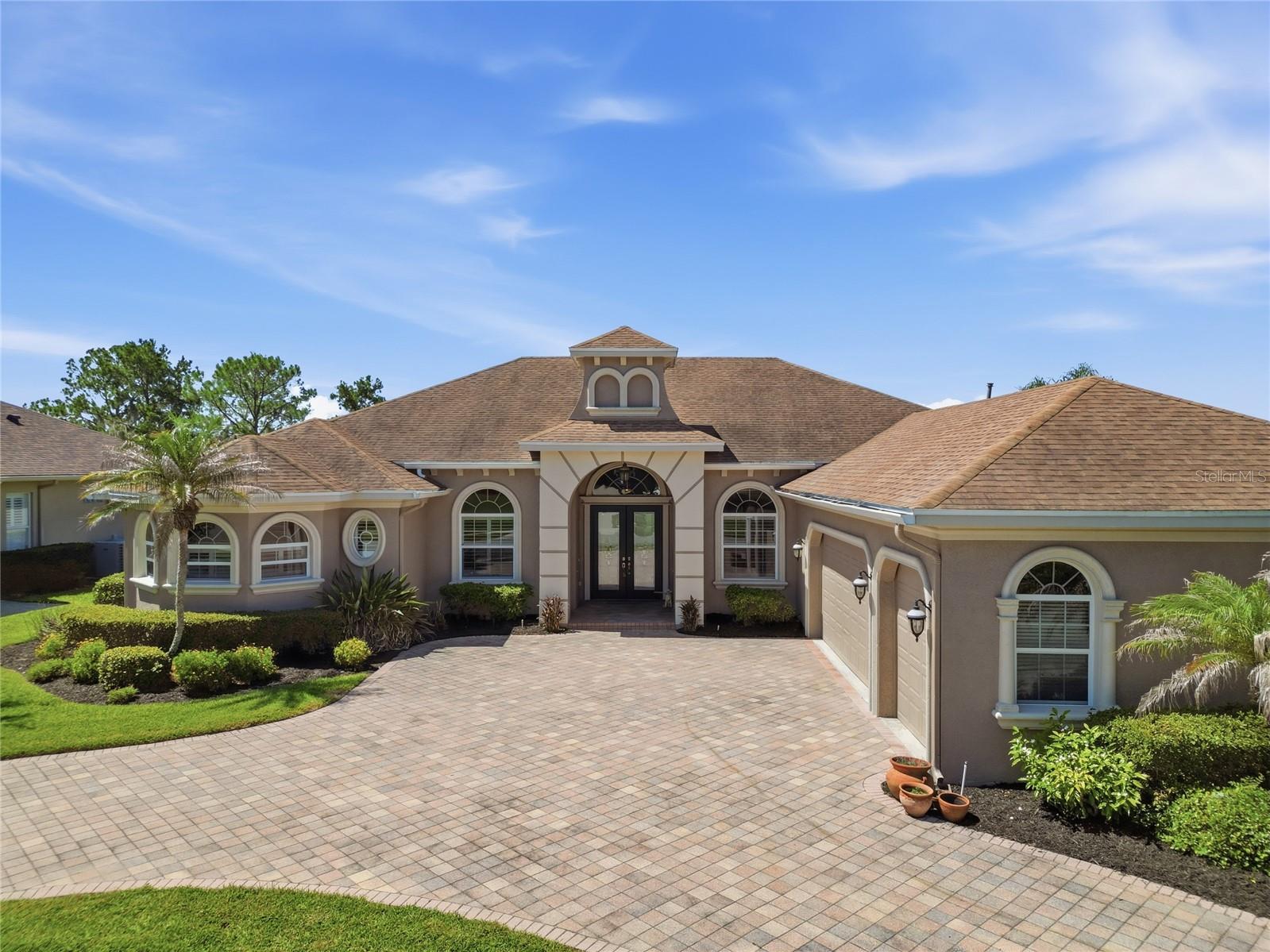 Set along the fairways of the highly sought-after Eaglebrooke community in South Lakeland, this beautifully designed 3-bedroom, 3-bath, with an office, offers refined golf-course living with custom features and thoughtful architectural details throughout. A circular paver driveway leads to the three-car garage, creating a welcoming arrival and adding to the home’s curb appeal. Located within the community’s guard-gated entrance, the home enjoys a picturesque setting overlooking the seventh hole of the par-5 course and provides an exceptional blend of elegance, comfort, and functionality.

Step inside to a spacious open-concept floor plan highlighted by soaring vaulted ceilings, decorative crown molding, tray ceilings, custom lighting, and an abundance of natural light. The thoughtfully designed layout creates a seamless flow between the main living areas, making the home equally suited for everyday living and entertaining.

The beautifully appointed kitchen serves as the heart of the home and features a gas range, built-in wine cooler, ample cabinetry, generous countertop space, and an inviting design that opens directly to the surrounding living and dining areas. Whether preparing a quiet meal at home or hosting family and friends, this kitchen offers both style and convenience.

The split-bedroom floor plan provides privacy for the spacious primary suite, which offers a peaceful retreat complete with a luxurious en-suite bathroom designed for relaxation. The two secondary bedrooms are thoughtfully positioned on the opposite side of the home and are connected by a convenient Jack-and-Jill bathroom, creating a functional arrangement for family members or overnight guests.

Extending along the entire rear of the home, the covered, paved, and screen-enclosed lanai creates an impressive outdoor living space with beautiful views of the golf course. Overlooking the seventh hole, this expansive patio provides the perfect setting for morning coffee, evening gatherings, outdoor dining, or simply enjoying the peaceful Florida surroundings year-round.

From the custom ceiling details and lighting to the open layout, private bedroom design, circular paver driveway, three-car garage, and expansive golf-front lanai, every element of this home has been thoughtfully considered. This exceptional property offers an opportunity to enjoy elegant living, beautiful fairway views, and the security of one of South Lakeland’s premier guard-gated golf communities. Schedule your private showing today.