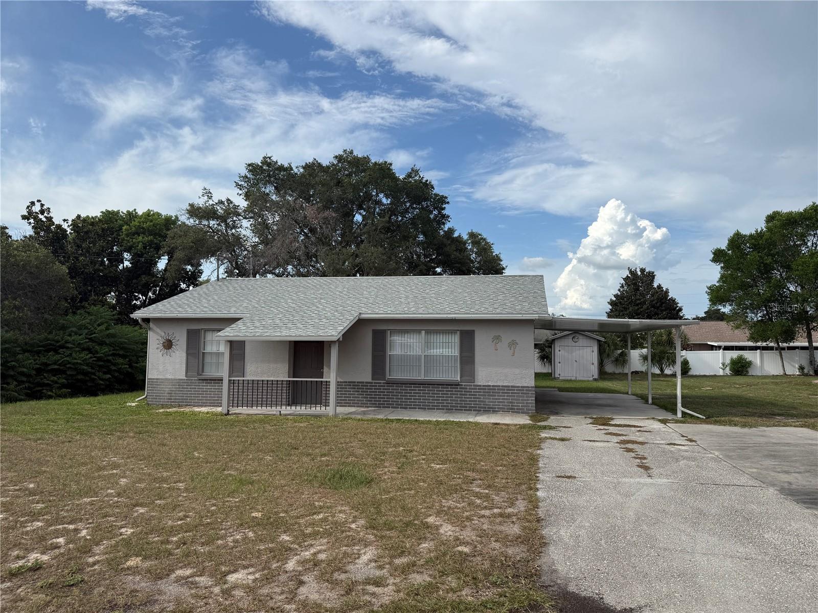 This concrete block home in Spring Hill is bursting with light and a welcoming feel. The living room flows seemlessly into the fully functional eat in kitchen complete with a washer and dryer right there, 'Plus, you've got easy access to the backyard through the screened lanai. Inside you'll find two generous bedrooms and a bath that was built back in 1985, covering 1390 total sq. It's all set on an 80x125 lot and the best part? There's no homeowners association. You'll also have covered parking with a carport and shed in the backyard. The home has been freshly painted both inside and out, with crown molding, ceiling fans, and all-tile and wood laminate flooring- no carpets here! Plus, a brand new roof was installed in 2026, newer appliances and everything you need to make it your own. Offered fully furnished so it's ready to move in right away!
