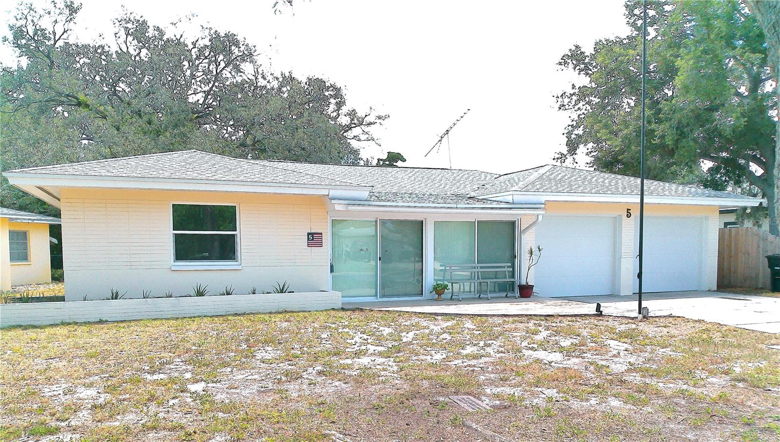 SkyCrest & Keystone Manor. Looking to move to Clearwater? Add this 3 Bedroom / 2 Bathroom / 2 Car Garage, Block Home to your tour itinerary.  It has everything you've been looking for & MORE! Located perfectly in Mid-Clearwater ensuring easy access to EVERYWHERE.  Non-Evacuation & Non-Flood Zone.  Situated on an extra deep lot providing generous outdoor space for pets & humans alike.  Inside you'll find an Open Concept, Split Plan with 2 Primary Suites!  When you enter, you'll find yourself in the "Artist's Studio".  It is an enclosed porch that could be used as a playroom, office or a place for creative types to "Let it Happen".  Then, step up into your large Living Room.  Furniture placement won't be a problem with nearly 1500 sq. ft. to work with.  The kitchen has Farmhouse Flair.  Whimsical cabinet pulls and polished wood countertops add warmth, while the Black-Stainless Appliances offer a sleek, modern edge.  The Range is propane gas for constant flame and temperature.  A large walk-in pantry offers all the storage a chef could want.  The Florida Room can accommodate a Formal Dining Set or use it as a 2nd media room or Family Room.  It opens out to a covered Back Patio, Deck and Large Backyard.  Back inside, you'll find 2 Primary Bedrooms.  One has Garage access and may be perfect for your young adult or In-Laws who want to come & go through a separate door.  This room is good sized and will easily fit a Queen bed & dresser. The Ensuite Bathroom contains a walk-in closet and large shower.  On the other side of the house is the 2nd Primary Bedroom.  Put your King-sized Bed Set here. The 2nd Bathroom is accessed from the hallway or from the 2nd Primary Bedroom... Super convenient.  The large shower is curb-less, allowing for rolling shower chairs if need be.  The 3rd Bedroom will accommodate a Queen-sized bedroom set.  It has a Walk-in Closet too.  Consistent Engineered Hardwood covers the floors.  Are you "Handy"?  The Oversized 2 Car Garage has loads of cabinets for storage and a wonderful peg-board wall over a long workbench.  Your Laundry is located here, along with a utility sink and the house mechanicals.  2015 A/C, 2022 Roof, 2024 Tankless Hot Water Heater.  Are you still in need of Workspace?  Don't worry!  In the Back yard are 3 Out-Buildings.  A Workshop with power and a wall A/C unit, A Garden Shed, (or She-Shed Maybe??) and a Lawn Tool Shed for mowers and the like.  SkyCrest and Keystone Manor are great neighborhoods that are merely blocks away from Crest Lake Park, minutes away from the country's best beaches, and surrounded by fantastic dining and shopping.  Super easy to commute to Tampa, St. Petersburg, Dunedin & Safety Harbor.  Superb grocery options and medical facilities are close by as well. Calling All Veterans!!  The existing VA 2.75% mortgage may be assumable with your Veterans Benefits.  There are so many reasons to make this home one you don't miss.  Schedule your private showing right away.
