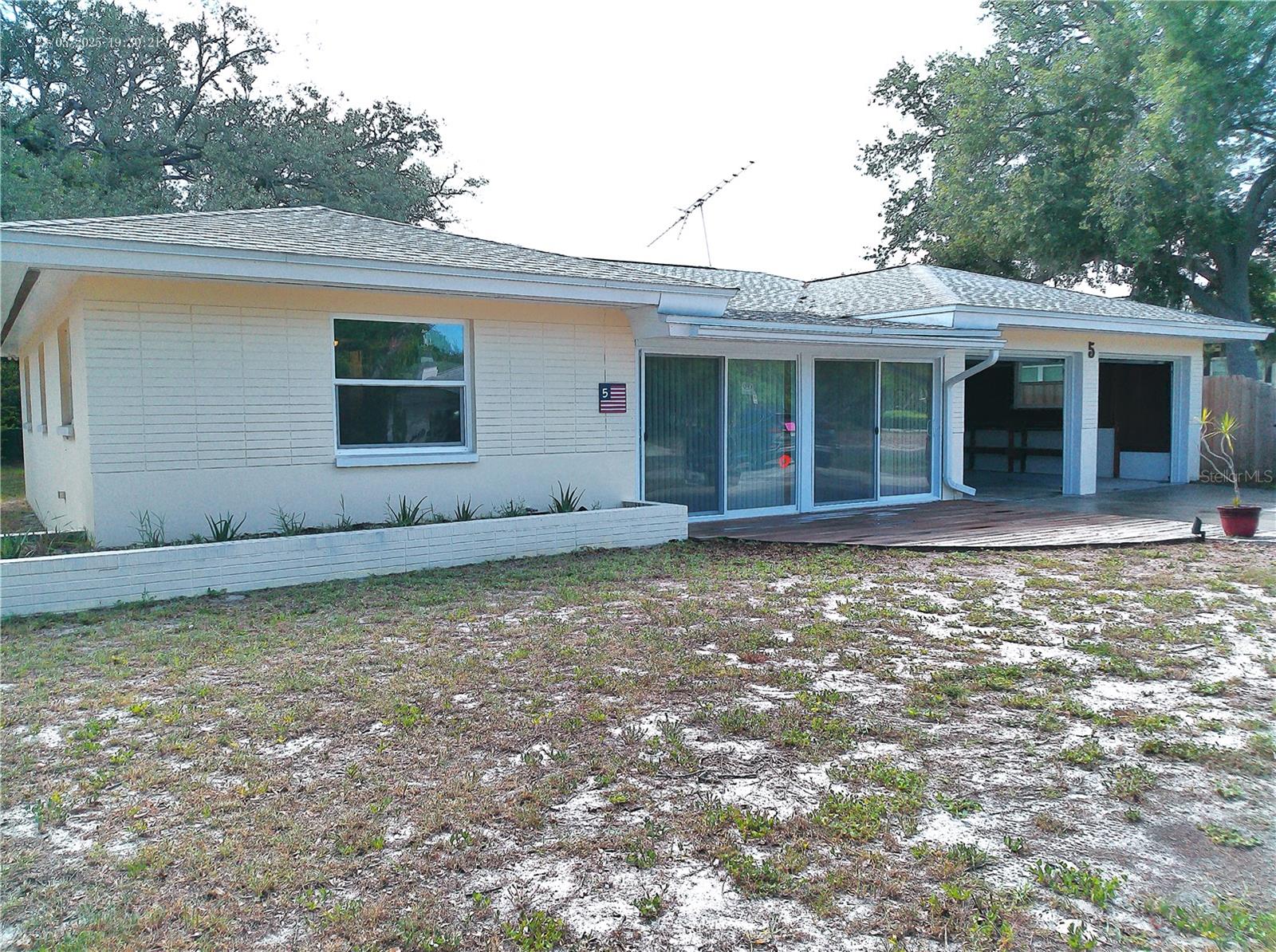 SkyCrest & Keystone Manor. Looking to move to Clearwater? Add this 3 Bedroom / 2 Bathroom / 2 Car Garage, Block Home to your tour itinerary.  It has everything you've been looking for & MORE! Located perfectly in Mid-Clearwater ensuring easy access to EVERYWHERE.  Non-Evacuation & Non-Flood Zone.  Situated on an extra deep lot providing generous outdoor space for pets & humans alike.  Inside you'll find an Open Concept, Split Plan with 2 Primary Suites!  When you enter, you'll find yourself in the "Artist's Studio".  It is an enclosed porch that could be used as a playroom, office or a place for creative types to "Let it Happen".  Then, step up into your large Living Room.  Furniture placement won't be a problem with nearly 1500 sq. ft. to work with.  The kitchen has Farmhouse Flair.  Whimsical cabinet pulls and polished wood countertops add warmth, while the Black-Stainless Appliances offer a sleek, modern edge.  The Range is propane gas for constant flame and temperature.  A large walk-in pantry offers all the storage a chef could want.  The Florida Room can accommodate a Formal Dining Set or use it as a 2nd media room or Family Room.  It opens out to a covered Back Patio, Deck and Large Backyard.  Back inside, you'll find 2 Primary Bedrooms.  One has Garage access and may be perfect for your young adult or In-Laws who want to come & go through a separate door.  This room is good sized and will easily fit a Queen bed & dresser. The Ensuite Bathroom contains a walk-in closet and large shower.  On the other side of the house is the 2nd Primary Bedroom.  Put your King-sized Bed Set here. The 2nd Bathroom is accessed through from the hallway or from the 2nd Primary Bedroom. Super convenient.  The large shower is curb-less, allowing for rolling shower chairs if need be.  The 3rd Bedroom will accommodate a Queen-sized bedroom set.  It has a Walk-in Closet too.  Consistent Engineered Hardwood covers the floors.  Are you "Handy"?  The Oversized 2 Car Garage has loads of cabinets for storage and a wonderful peg-board wall over a long workbench.  Your Laundry is located here, along with a utility sink and the house mechanicals.  2015 A/C, 2022 Roof, 2024 Tankless Hot Water Heater.  Are you still in need of Workspace?  Don't worry!  In the Back yard are 3 out-buildings.  A Workshop with power and a wall A/C unit, A Garden Shed, (or She-Shed Maybe??) and a Lawn Tool Shed for mowers and the like.  SkyCrest and Keystone Manor are great neighborhoods that are merely blocks away from Crest Lake Park, minutes away from the country's best beaches, and surrounded by fantastic dining and shopping.  Super easy to commute to Tampa, St. Petersburg, Dunedin & Safety Harbor.  Superb grocery options and medical facilities are close by as well. Calling All Veterans!!  The existing VA 2.75% mortgage may be assumable with your Veterans Benefits.  There are so many reasons to make this home one you don't miss.  Schedule your private showing right away.