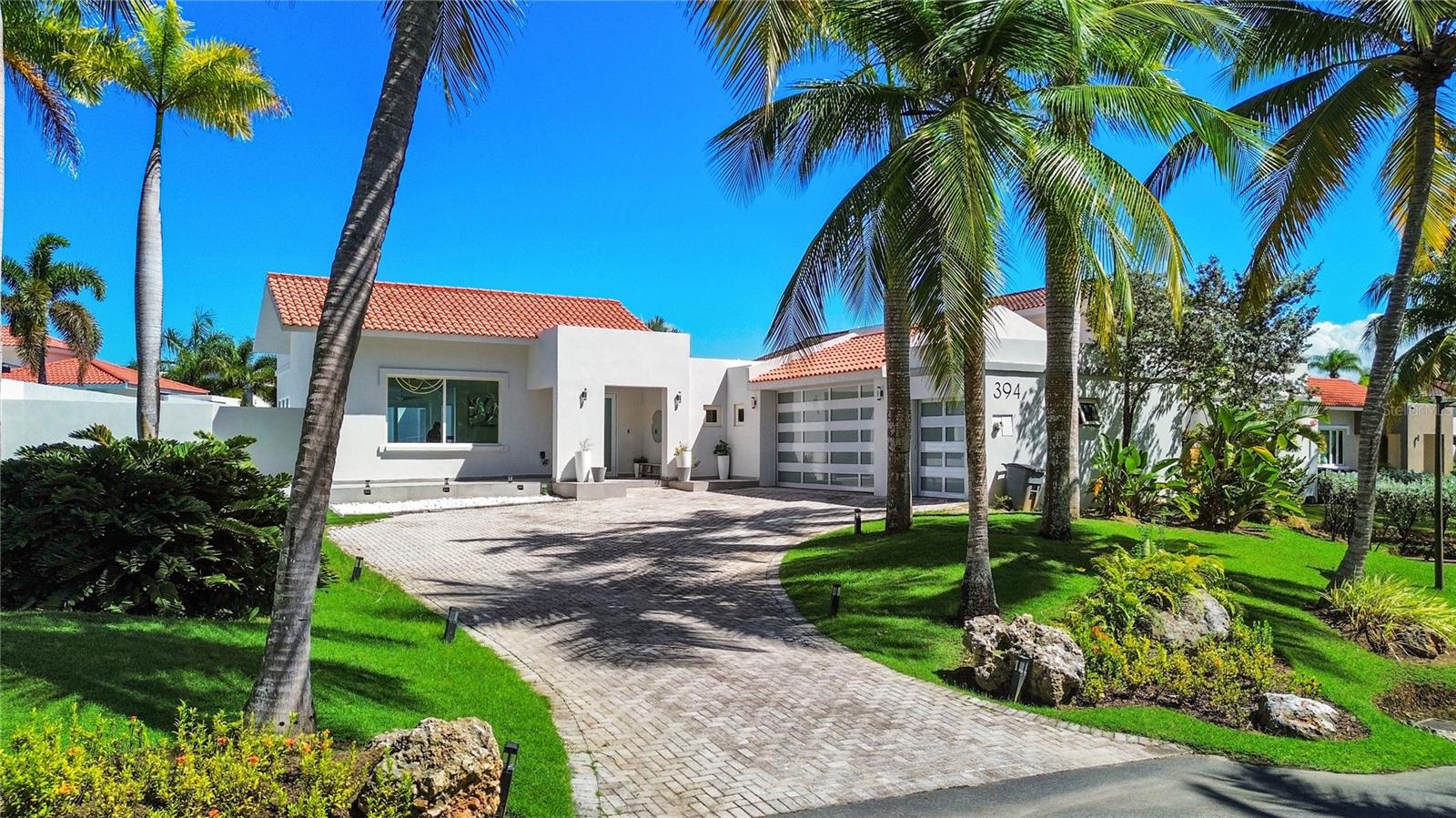 Located within the prestigious Dorado Beach East, a Ritz-Carlton Reserve community, this exceptional 4,200 sq. ft. residence presents a rare opportunity to own a fully furnished, meticulously renovated home in one of Puerto Rico’s most exclusive communities. Originally reimagined six years ago with expanded square footage, the property now offers 4 spacious bedrooms and 4.5 bathrooms, designed with both sophistication and functionality in mind. 
The interior of the home showcases European-imported, non-slip tile throughout, a striking hall of mirrors, and curated furnishings by Roche Bobois, creating a refined yet contemporary feel. The gourmet kitchen is outfitted for the ultimate chef with premium appliances - including a Wolf induction cooktop, Thermador oven, microwave, refrigerator, and wine fridge, complemented by exquisite Blue Pearl labradorite granite countertops and custom California Closet pantry storage. 
Designed for effortless living, the home features a seamless indoor-outdoor open concept, allowing open-air flow throughout the main living areas with floor to ceiling sliding doors. The expanded primary suite is a private retreat, complete with widened hallways, full blackout capability, and advanced sound insulation for complete tranquility. The en-suite bathroom features a luxurious double vanity and a porcelain bathtub. 
Additional highlights throughout the home include Scavolini sinks, Toto and Kohler fixtures, an LG washer and dryer, fully automated smart-home systems with Alexa integration, automatic blinds, and a comprehensive security system. The property also includes an enclosed garage and zero-maintenance hardscaping, ensuring ease of ownership without compromise. A four-passenger Garia golf cart can also be purchased to further enhance convenience and leisure. 
Outdoors, a completely private oasis awaits, featuring a saltwater pool with Pentair equipment, a heated jacuzzi with turbo jets and ambient lighting, and an outdoor heated shower. The home is pre-plumbed and ready for an outdoor sauna, further enhancing its resort-style appeal. Sustainability meets luxury with a full solar system generating 15 kilowatts of power, supported by two Tesla batteries and a full backup generator, resulting in virtually zero electric costs.  
As a resident of Dorado Beach, enjoy access to the world-class amenities of the Ritz-Carlton Reserve, including championship golf courses, pristine beaches, spa facilities, fine dining, and exclusive concierge services - delivering an unparalleled lifestyle defined by privacy, comfort, and exceptional design. Don’t miss this rare opportunity to acquire a property of this caliber.