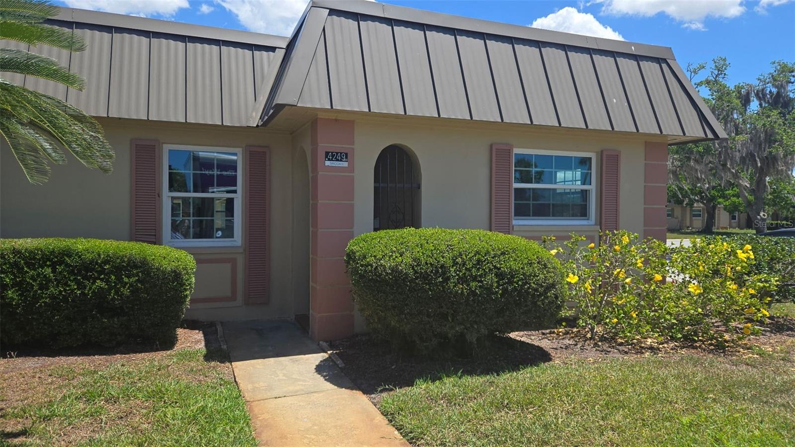 One or more photo(s) has been virtually staged. Welcome to 4249 Stratford Rd, a beautifully updated 2-bedroom, 2-bathroom end-unit condo located in the desirable Gardens of Beacon Square, a gated 55+ community in New Port Richey. 

Offering approximately 1,050 sqft of thoughtfully designed living space, this move-in-ready home combines modern upgrades with low-maintenance Florida living. Inside, you'll find brand-new tile flooring.

The entire interior has been painted in neutral tones, giving the home a bright, fresh feel from the moment you walk in. Updated electrical provides added safety and long-term peace of mind, while all kitchen appliances and the water heater are brand new, adding style and functionality to the home. As a desirable end unit, this property enjoys additional privacy and abundant natural light -- features that truly set it apart. 

The comfortable living and dining areas offer a welcoming space for relaxing or entertaining guests. Step outside and enjoy peaceful pond views from the rear patio, offering a tranquil setting to unwind and enjoy Florida living. The primary bedroom offers comfort and privacy, while Bedroom 2 includes a closet, making it ideal for guests, family members, or a home office setup. 

Additional storage is plentiful with a large utility closet and two additional storage closets located within the common area. The property also includes a one-stall covered carport for convenient protected parking. Residents of Gardens of Beacon Square enjoy access to a community clubhouse, swimming pool, shuffleboard courts, and beautifully maintained grounds. 

Condo pays HOA. Condo monthly is 818. 
The HOA provides exceptional value and includes comprehensive property insurance, water, landscaping, pool and clubhouse maintenance, cable TV, exterior maintenance, and common area upkeep, creating a truly stress-free lifestyle. Conveniently located near shopping, dining, medical facilities, and Gulf Coast beaches, this home delivers comfort, convenience, and value. Priced to sell and ready for immediate occupancy -- don't miss this opportunity to own a fully updated end-unit condo with pond views in one of New Port Richey's established communities. Some listing photos have been virtually staged using AI technology to help illustrate the property's potential. Furnishings, décor, and enhancements shown in staged images are for visual representation purposes only. Buyers are encouraged to verify all features during their personal inspection.