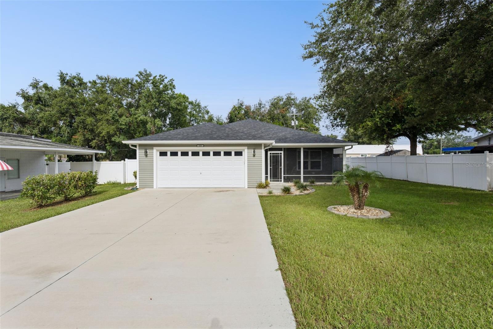It feels like new and only built in 2024. Great details in the floor plan, luxury vinyl floors, high baseboards, pleated window shades throughout the house, and lots of screened porches in the front and back of the house. Primary bathroom has dual sinks, Corian countertops, and walk in shower. Kitchen features wood cabinets, granite countertops with appliances to be included. Laundry room includes the washer and dryer. Two car garage, laundry sink, attic with stairs and an extra refrigerator. No HOA. Close proximity to the lake either by golf cart or vehicle. If you stand in the driveway you can actually see the lake in the distance.