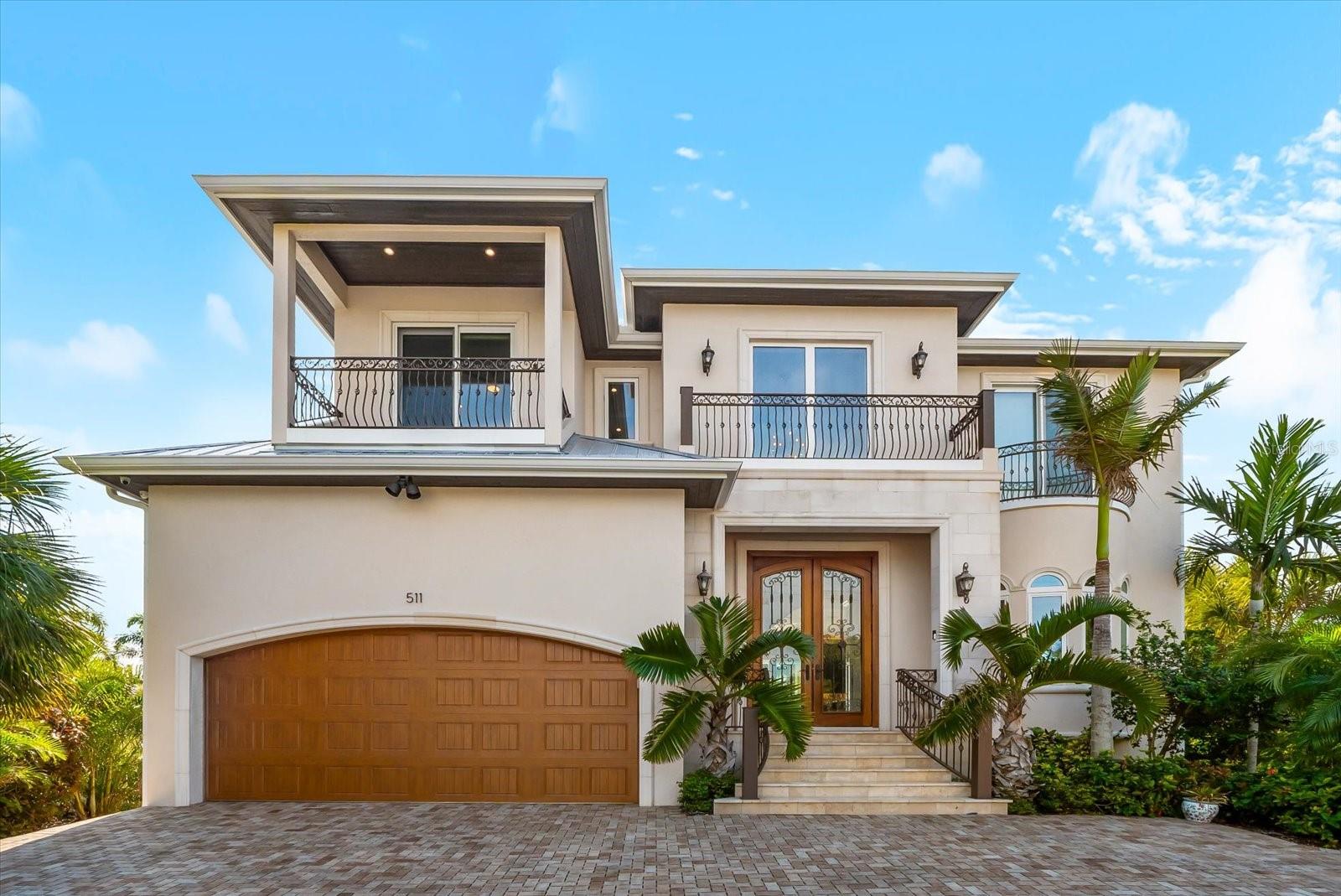 Experience the ultimate island paradise in this practically NEW CONSTRUCTION LUXURY WATERFRONT HOME, thoughtfully designed with solid concrete block construction and cutting-edge design and technology. Spanning over 3,300+ square feet, this stunning residence offers 4 bedrooms and 5 full bathrooms, blending elegance, durability, and effortless coastal living.

Perfectly positioned just a few short blocks from the Gulf of America, the home also boasts PANORAMIC Intracoastal waterfront views, creating a rare and breathtaking dual-water lifestyle. The half-elevated design provides peace of mind while enhancing views and architectural appeal.

Indoors, no detail has been overlooked. Highlights include a butler’s pantry, an upstairs coffee bar just outside the primary suite, and expansive open-concept living spaces ideal for both everyday comfort and entertaining. The luxurious primary retreat offers a serene escape with spa-inspired finishes and seamless indoor-outdoor flow.

Step outside to your private waterfront oasis featuring an infinity pool, hot tub, and a fully equipped outdoor kitchen, all designed to maximize sunset views and coastal breezes. Whether hosting guests or enjoying a quiet evening under the stars, this outdoor space is truly exceptional.

With waterfront living, modern luxury, and a premier island location, this home offers everything you could ask for—and more. A rare opportunity to own a refined coastal sanctuary that perfectly balances style, comfort, and location.  Schedule your private showing today!