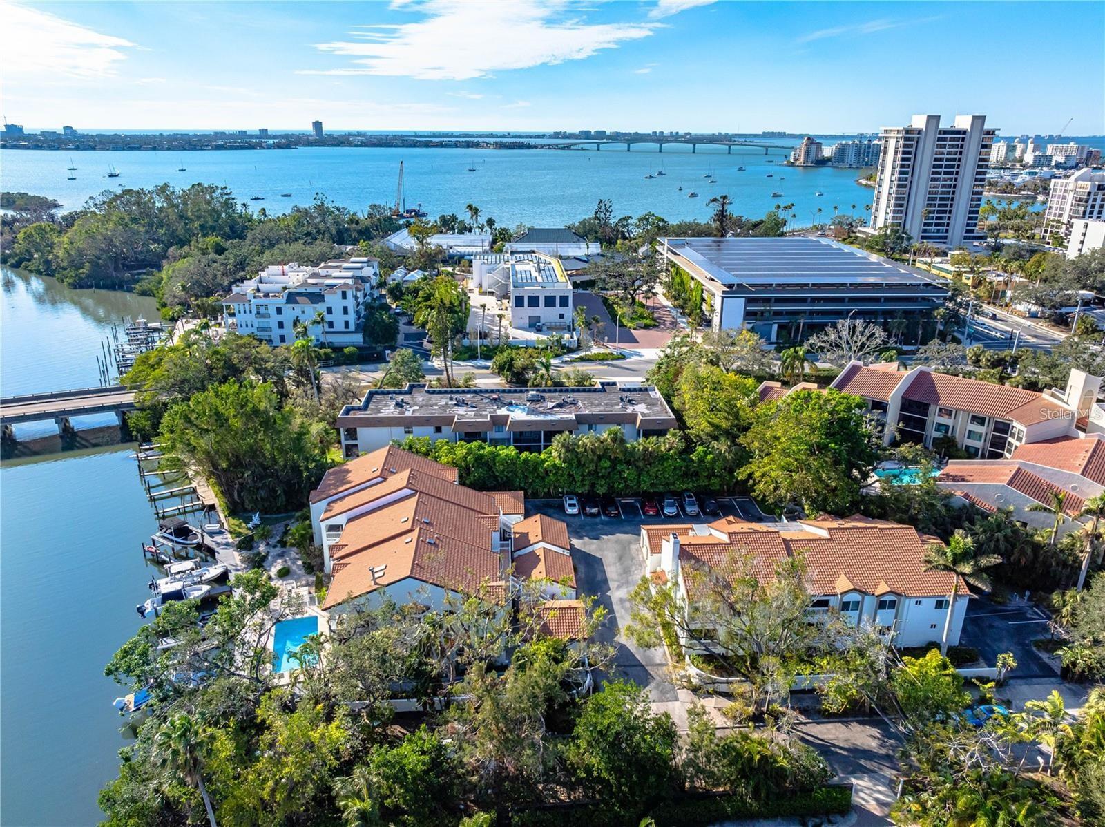 Live the Downtown Waterfront Lifestyle – Deeded Dock Included! 
Brand new exterior paint! This beautifully renovated 2-bed, 2-bath condo with a den (optional 3rd bedroom) is a rare find in Sarasota’s desirable West of the Trail neighborhood. Located in Hudson Landings, a quiet 12-residence community just minutes from downtown and the bay, this light-filled second-floor corner unit offers modern updates and an unbeatable lifestyle.  The list price includes a deeded dock and a 10,000-lb boat lift—brand new with updated pilings and cradle—providing quick, direct access to Sarasota Bay and the Gulf of Mexico. Bring your boat and enjoy the ultimate Florida living experience!

Inside, you'll find a vaulted exposed-beam ceilings and abundant natural light with a sleek contemporary kitchen with custom cabinetry, newer granite countertops, glass tile backsplash, and top-of-the-line stainless steel appliances, including a built-in double oven and glass cooktop, and a spacious Italian-style shower in the updated bathrooms.  Plus a cozy wood-burning fireplace for cool evenings and an enclosed patio with large hurricane-rated sliding windows, creating a bright and inviting dining area

Step outside and you’re just a short walk to Marie Selby Botanical Gardens, the Sarasota Bayfront, and vibrant downtown Sarasota. This peaceful community also features a heated pool, lush landscaping, and a truly secluded atmosphere—no damage from recent storms Helene or Milton; docks and boats remained intact.