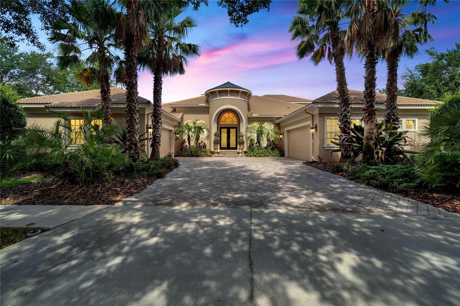 NEW PRICE FOR THE HOLIDAY WEEKEND! Excellence & elegance surround you at this magnificent, 5,000-SF home custom-built by Hannah Bartoletta in the security-gated enclave of Kestrelridge! On extra-sized land along a cul-de-sac, the property features an impressive pool lanai with a panoramic view of conservation woods & water. An outdoor kitchen & gas fireplace flank the heated pool & spa on a travertine-tiled deck with both screened & roof-sheltered spaces for all-weather enjoyment. Triple pocket sliders from the family room throw the home open for great entertaining, & of course, details are just as dazzling inside: coffered ceilings, crown molding, columns & arches, gorgeous granite, diagonal-tile floors & backsplashes, decorative listello, raised-panel wood cabinets, walk-in wine closet & so much more. A turret-style entrance welcomes you through leaded-glass double doors to a lovely foyer view that immediately captures the rear vista as well as the formal living & dining rooms with passage to the family room, gourmet kitchen & casual dining nook. The first level also includes the luxury owner’s suite, additional en-suite bed & bath for guests or in-laws, customized home theater, office, laundry room, plus lavatories for convenience both inside & beside the pool. Up a winding, wood-tread staircase are a bonus loft, third & fourth bedrooms, & third full bath. It’s all under a beautiful, barrel-tile roof with 3 AC units replaced in recent years for peace of mind. The stone-pavered driveway feeds a pair of 600-SF, 2-car, side-entry garages for a total of 4 bays plus extra storage or work space. Perhaps best of all, you’re home in incredible FishHawk Ranch with amenities ranging from aquatic center & sports complex to parks & trails, shops & restaurants, countless conveniences & some of the best schools in all of Florida! Don't wait to arrange your private viewing of this truly special property! Seller financing available.