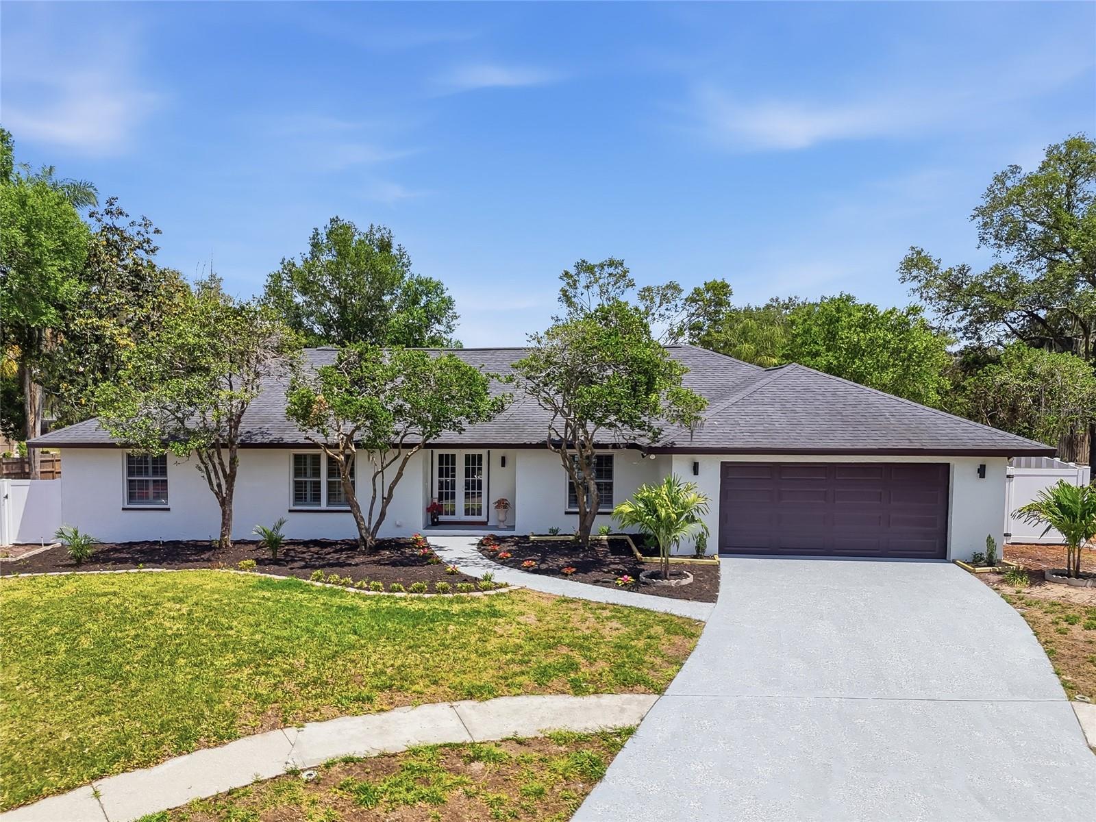 This 'rare gem' Valrico POOL home sits next to Buckhorn Gulf Club Estate has been beautifully updated and is located on a tree-lined, cul-de-sac street with 1 way in 1 way out and boasts charming curb appeal! This renovated home features cathedral ceilings with wood beams, a burning fireplace, and a private pool. This 4-bedroom, 3-bath, 2 living rooms, 2-car garage home sits in a NON-EVAC, NO Flood ZONE. Home blends classic Florida charm with thoughtful updates and modern smart home features, all set on a beautifully landscaped, oversized lot. Inside, you’re greeted by a formal living room, family room, dining spaces with views of the resurfaced pool (2026) and the fully fenced backyard (new in 2026) — perfect for entertaining. As you step inside the foyer, off to the left, you will find the separate formal living that are accented with oversized windows allowing natural light to filter in. Just past the foyer, you will find the open family room with stone front-wood burning fireplace, beautiful wood beams, vaulted ceiling, and double French doors leading to the lanai, which is large enough to entertain a sitting area, dining area, and still have room for a hot tub! The kitchen and family room combo is the heart of the home, featuring a cozy wood-burning fireplace, ample prep space, new appliances, and a sunny breakfast nook with sliders to the lanai. The family room floors were updated in 2026, bringing a fresh, modern tone. The private primary suite includes vaulted ceilings, dual walk-in closets, lanai access, a double sink, and a stand-alone shower. Three more spacious bedrooms are privately tucked away on the opposite side of the home, walk-in closets, as well as an additional bath with lanai access. Roof 2019. Updates/amenities include: New A/C HVAC, New Electric Panel, New windows, New Fence, Dry bar Area with wine fridge , Each bathroom confitures double sink vanity, New Washer & Dryer included inside the home separate room, Pool resurfaced  2026. Window treatments  new, Home has completed replumbing with permits and many more. No HOA fee, so bring your boat, trailers RV. Elementary, Middle and High school just 1 mile away. You wont be disappointed.