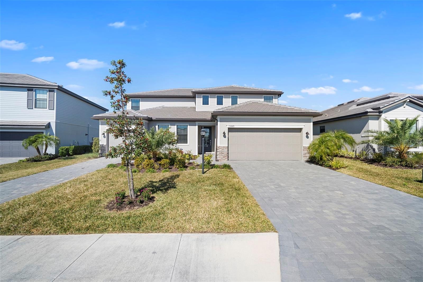 Experience refined lakefront living in this exceptional estate offering nearly 3,900 square feet of
thoughtfully curated space within one of Lakewood Ranch’s most sought-after gated
communities. Designed to elevate both everyday living and sophisticated entertaining, this
stunning two-story residence seamlessly blends elegance, comfort, and versatility.

The main home features five spacious bedrooms and three and a half baths, complemented by
a private attached Next Gen® “Home Within a Home®” suite—an exclusive retreat complete
with its own entrance, living area, bedroom, full bath, additional laundry, and private garage.
Perfectly suited for multigenerational living, distinguished guests, or a private executive office,
this space offers unparalleled flexibility without compromise.

At the heart of the home, a light-filled open-concept design creates a seamless flow between
the kitchen, dining, and living areas, extending effortlessly to the covered lanai and tranquil
lake views beyond. The chef-inspired kitchen is both functional and striking, featuring an
oversized center island, granite countertops, stainless steel appliances including a gas range,
and refined finishes—ideal for both intimate gatherings and elevated entertaining.

Upstairs, a thoughtfully designed layout provides privacy and comfort, highlighted by a versatile
loft, well-appointed secondary bedrooms, and a serene primary suite offering a spa-like bath
experience designed for relaxation and renewal.

A rare three-car garage adds both convenience and distinction, providing ample space for
vehicles, storage, or recreational pursuits.

Life in Lorraine Lakes is defined by resort-style luxury and vibrant community living. Residents
enjoy 24/7 guard-gated security, maintenance-free living with lawn care included, and bundled
internet and cable services. The centerpiece of the community is the expansive 25,000-square-
foot amenity center, designed to rival private resorts.

At its core is the beautifully designed clubhouse and its highly sought-after full-service
restaurant and bar—an inviting, upscale yet relaxed social hub where residents gather to dine,
unwind, and connect. The restaurant features a diverse, chef-inspired menu ranging from

casual favorites to elevated cuisine, complemented by a full bar offering craft cocktails, fine
wines, and premium selections. Whether enjoying a casual lunch by the pool, an evening
cocktail with lake views, or watching live sporting events in a lively atmosphere, the experience
is both sophisticated and welcoming—bringing a true country club feel to everyday living.

Additional amenities include resort-style pools, a state-of-the-art fitness center, aerobics
studio, indoor basketball court, tennis and pickleball courts, beach volleyball, bocce, a putting
green, arcade, playground, and scenic walking and biking trails—all supported by a dynamic
calendar of curated social events.

Ideally located in the heart of Lakewood Ranch, this residence offers convenient access to top-
rated schools, upscale shopping, fine dining, and is just a short drive to Florida’s world-
renowned Gulf Coast beaches, as well as Sarasota, St. Petersburg, and Tampa.

This is more than a home—it is a lifestyle defined by elegance, flexibility, and resort-inspired
living. Schedule your private showing and discover the elevated experience that awaits.