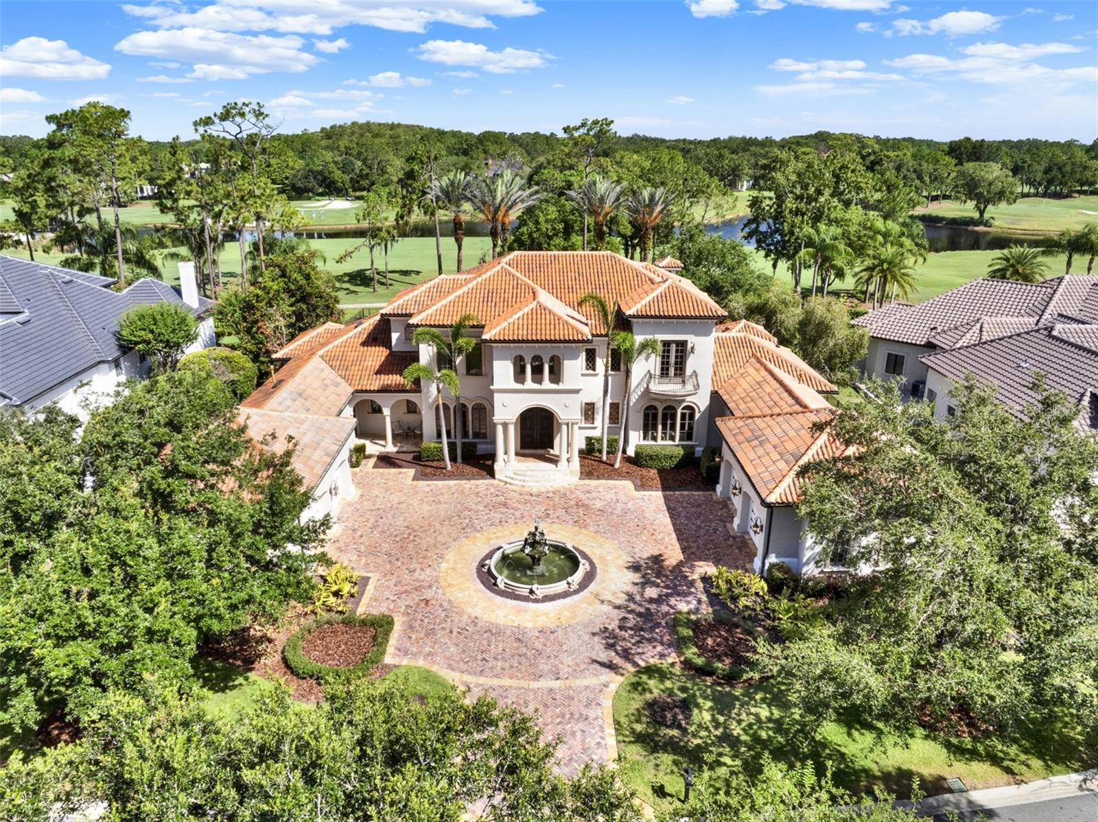 Luxury Living in Lake Nona Golf & Country Club
9589 Blandford Road | 6,101 SF | 5 Beds | 6.5 Baths | Theater | Golf & Pond Views
Perfectly positioned in the renowned Lake Nona Golf & Country Club, this reimagined 6,101-square-foot Mediterranean estate seamlessly blends timeless elegance with modern sophistication. With sweeping golf course and tranquil pond views, this meticulously crafted residence invites you to experience the pinnacle of luxury living.
From the moment you arrive, the home makes a lasting impression with a grand stone paver driveway, striking fountain centerpiece, and lush, manicured landscaping. Inside, a dramatic two-story foyer with a sweeping staircase and sun-drenched interiors welcomes you to a space where architectural design and quality craftsmanship converge.
This exceptional estate offers five spacious bedrooms and six full bathrooms plus one half bath, including a luxurious first-floor primary suite featuring spa-inspired finishes, expansive walk-in closets, and peaceful views of the private outdoor oasis. A main-level guest suite provides flexible accommodations ideal for multigenerational living or long-term guests.
Designed for comfort and convenience, the home also features a private theater room for immersive entertainment, and an oversized executive office perfect for working from home. Formal and casual living spaces flow effortlessly throughout, adorned with custom millwork, designer finishes, and thoughtful attention to every detail.
At the heart of the home lies the gourmet chef’s kitchen, equipped with top-of-the-line appliances, a large center island, custom cabinetry, and a spacious walk-in pantry. The open-concept design connects the kitchen to the living and dining areas and extends seamlessly to the outdoors—perfect for both intimate family gatherings and large-scale entertaining.
Step outside to enjoy a resort-style pool and spa, surrounded by a covered lanai with a fully equipped summer kitchen, ideal for year-round outdoor living. Additional amenities include a four-car garage plus a dedicated golf cart garage, and a whole-house generator for added peace of mind.
Ideally located just minutes from Orlando International Airport, Lake Nona Medical City, USTA National Campus, Boxi Park, and top-rated A-schools, this property also offers easy access to the 417 Greeneway and 528 Beachline.
9589 Blandford Road is more than a home—it’s a lifestyle. Set in one of Central Florida’s most coveted gated communities, this is a rare opportunity to own a custom estate where luxury, privacy, and convenience meet.
Don’t miss out on this unique offering—schedule your private tour today.