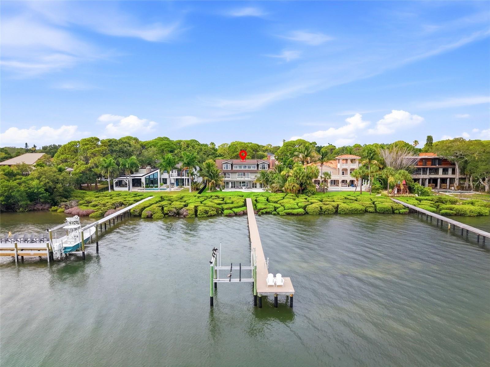 Under contract-accepting backup offers. Welcome to one of the most spectacular waterfront homes in St. Petersburg's highly sought-after Pink Streets neighborhood. Positioned on 92 feet of open waterfront, this exceptional residence captures breathtaking 180-degree views across Tampa Bay, with the iconic Sunshine Skyway Bridge serving as the centerpiece of an unforgettable backdrop.

Offering more than 5,000 square feet of thoughtfully designed living space, this six-bedroom, five-and-a-half-bathroom architectural masterpiece was completely reimagined during an extensive 2021 renovation that took more than a year to complete. Every detail was carefully considered to create a home that is as functional as it is stunning.

The first level is designed for effortless entertaining, featuring two spacious living areas, a show-stopping chef's kitchen with a separate prep kitchen, and two generously sized guest suites, each with its own private en-suite bathroom.

Upstairs, the second level is anchored by an impressive primary suite overlooking the water, complete with a luxurious en-suite bath. An additional guest bedroom, full bathroom, and expansive waterfront living room open to a covered balcony where the panoramic views truly steal the show.

The third level offers incredible flexibility with yet another living area, a convenient coffee bar, two additional bedrooms, and a full bathroom, ideal for guests, multigenerational living, or creating private retreats throughout the home.

Beyond its stunning design, this home has been meticulously updated with major improvements, including a complete renovation in 2021 featuring updated plumbing and sewer lines, a new dock and 10,000-pound boat lift (2022), a $90,000 pool renovation (2024), and impact-rated windows (2025). Completing the home is a durable stone-coated steel tile roof, providing exceptional longevity and peace of mind.

With its rare combination of expansive open-water views, exceptional craftsmanship, flexible floor plan, and extensive updates, this is a truly one-of-a-kind waterfront opportunity in one of St. Petersburg's most desirable neighborhoods.