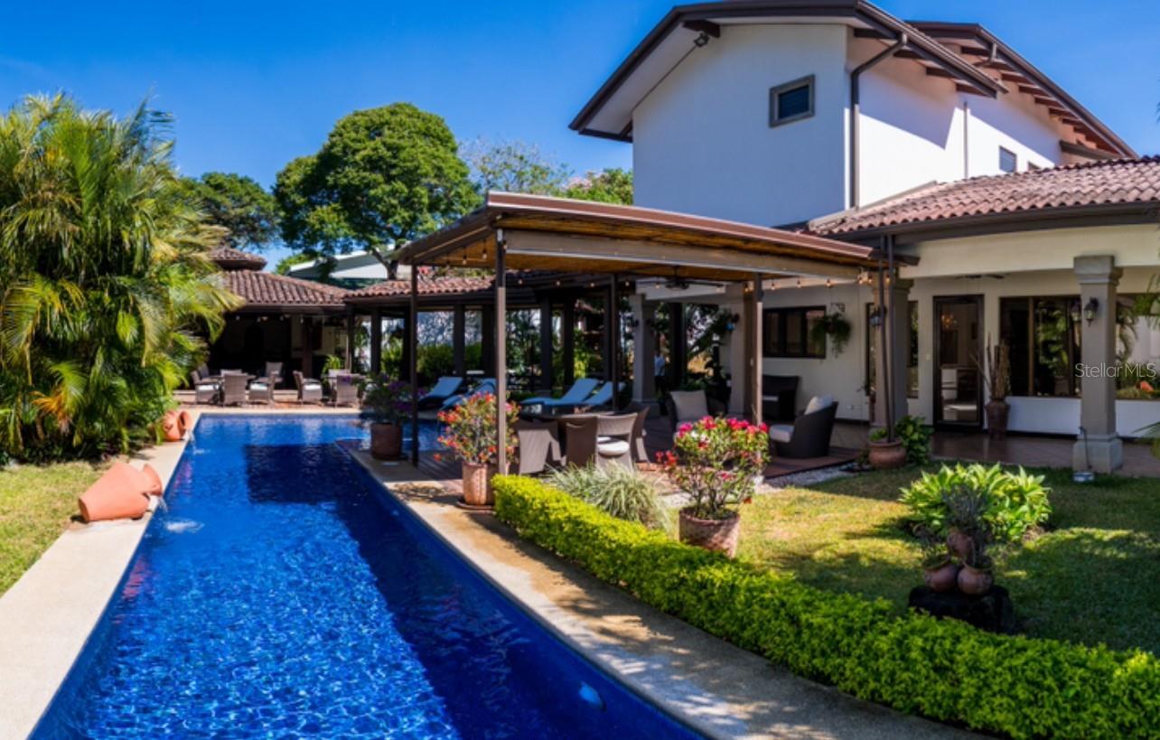 Where Life Slows Down and You Begin Again! Sun & Green Retreat | Santa Ana, Costa Rica. 
There’s a place where the mornings begin with birdsong, where sunlight dances across a saltwater pool, and time feels like it belongs to you again.
Nestled in one of Costa Rica’s most coveted neighborhoods, Sun & Green Retreat isn’t just a home, it’s a return to balance, to beauty, to intention. This private estate was designed to be lived in deeply: from its lush organic garden and fruit trees to the handcrafted wood bar, open-air rancho, and serene walking paths that lead you nowhere in particular, except inward.
Behind its gated entrance, the world slows down. Inside, natural light spills through open spaces, fine finishes wrap every corner with warmth, and every room speaks the language of comfort and sophistication.
This is a home for dreamers. For those who host with heart. For those who know the true luxury isn’t just about what you own,-it’s about how you live.
Whether you’re seeking a personal sanctuary or a strategic international investment, Sun & Green Retreat offers a life of beauty, privacy, and connection, just minutes from the vibrancy of San José and the calm of the Pacific coast.