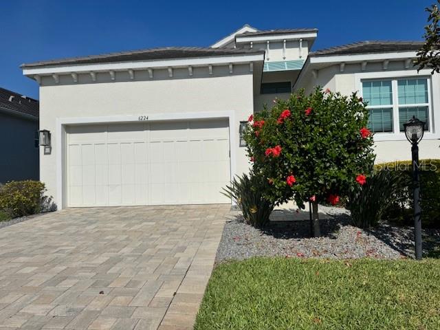 PRICE IMPROVEMENT FOR THIS MUST SEE IN LEGENDS BAY!  Begin your Florida dream lifestyle now.  This home is available immediately! This 2 bedroom, 2 bath home with den in desirable Legends Bay is the perfect home for those looking for a home near the famous crystal white sand beaches of Bradenton, Anna Maria and Longboat Key.  Enjoy these local beaches with beach markets, water sports and boating or just relax and enjoy the sparkling blue waters.  Legends Bay is a short drive from IMG Academy and IMG Golf Club.  Located in a gated community, this home has a screened lanai with plenty of space for entertaining or relaxing in your own private pool. Natural gas and water rough ins are provided should you want to add an outdoor kitchen.
This home MOVE IN READY with modern, decorator finishes including white cabinetry, quartz counter tops and stainless steel kitchen appliances. All appliances are included and natural gas supplies a 5 burner range, hot water heater and dryer.  
Home is elevated and provides impact windows and impact designer front and garage doors for peace of mind for year-round living or if you are a traveler wanting less worries while doing so.  HOA includes contracted lawn maintenance, irrigation, community clubhouse and pool and gated entrance expenses.
The large primary ensuite includes 2 walk-in closets, and a large bath with dual sinks, shower and soaking tub. You have access to the outdoor/lanai from this room as well.  The secondary bedroom and den are situated to the front of the home providing privacy for guests.
Enjoy the surrounding areas by easily accessing downtown Bradenton and Sarasota.  Both cities have a plethora of casual and fine dining restaurants, year round cultural events and venues to enjoy the beautiful Florida experience year round. 
Sarasota International Airport is a 15 minute drive away providing access to flights for business or vacation.  Tampa Internation Airport is one hour away.