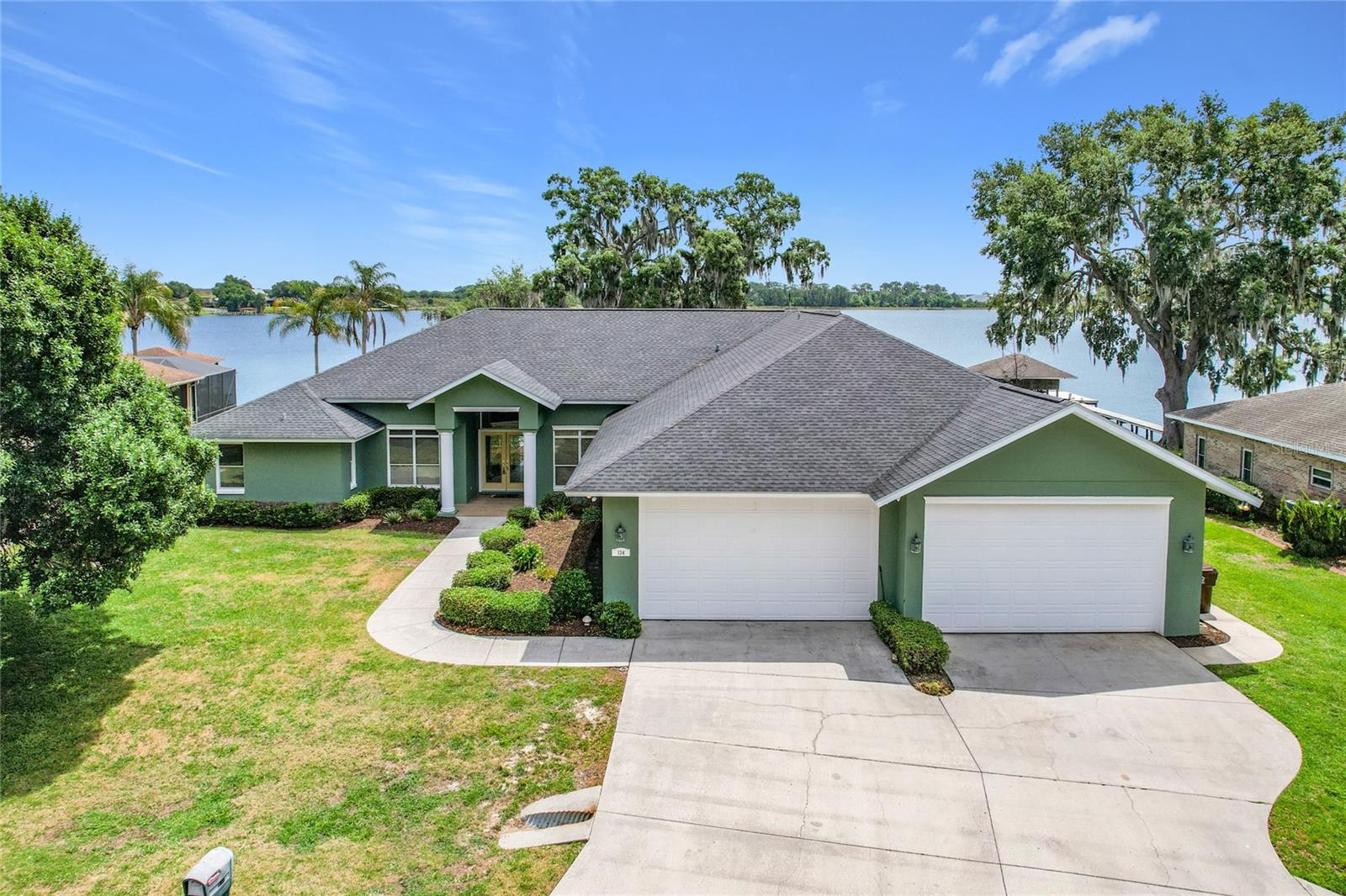 One or more photo(s) has been virtually staged. Welcome to this stunning 4-bedroom, 3-bath lakefront home located in the highly sought-after Sandy Pointe community of Polk City, FL. Perfectly situated on a premier just over half-acre lot, this property offers privacy, tranquility, and breathtaking views of Big Lake Agnes - known for its excellent fishing and boating, creating the perfect setting for both relaxation and recreation. Step inside to discover high tray ceilings in the formal living and dining areas, enhancing the home’s spacious and elegant feel. The thoughtfully designed split floor plan features a private primary suite along with an office or optional bedroom on one side of the home, while two additional bedrooms are located on the opposite side, providing comfort and privacy for family or guests. Enjoy Florida living at its finest with a screened-in pool and expansive lanai overlooking the water - ideal for entertaining or unwinding while taking in the serene lake views. This home features a 1,688 square foot freshly painted 6 car garage for your car enthusiast or for that someone that likes a lot of toys! The property also includes a large custom greenhouse, perfect for gardening enthusiasts. Additional highlights include fresh interior paint and a roof replaced in January 2021, offering peace of mind for years to come. This exceptional lakefront home combines comfort, functionality, and scenic beauty - an opportunity you don’t want to miss.