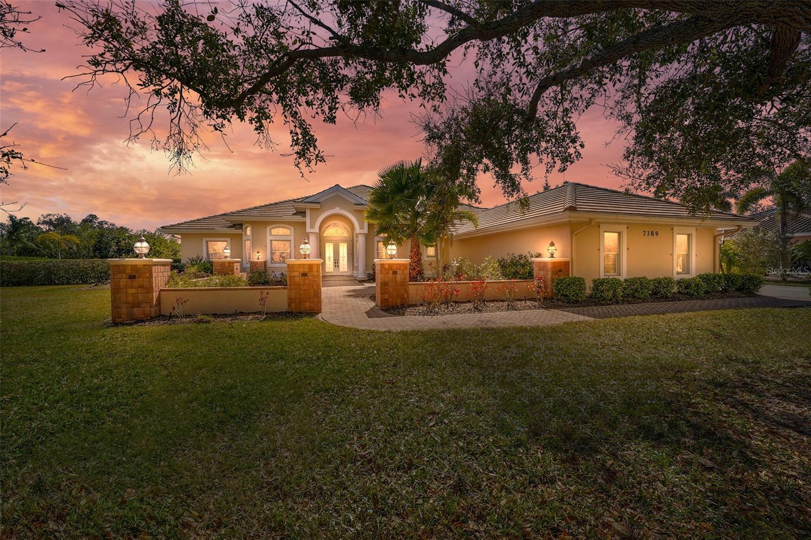 Virtually Staged. Welcome to 7389 South Serrano Drive—an exceptional residence where space, craftsmanship, and serene water views come together beautifully. Set on one of the community’s oversized lots and built by renowned luxury builder John Cannon Homes, this expansive 4,405-square-foot home delivers the quality, design, and upgrades today’s buyers are looking for.

From the moment you arrive, the home makes a statement. Double front doors open into a grand living room where your eyes are immediately drawn to the sparkling pool, tranquil lake, and inviting lanai beyond—an effortless blend of indoor and outdoor living.

To the right, a stunning formal dining room offers the perfect setting for elegant dinners and memorable gatherings. Just beyond, the newly updated kitchen is both beautiful and functional, now elevated with gorgeous quartz countertops, a sparkling tile backsplash, and updated wide-plank flooring that brings warmth and character—creating an inviting space with a subtle French country feel. The kitchen flows seamlessly into a spacious family room designed for everyday living and entertaining alike. Throughout the home, sliding glass doors open wide, extending your living space outdoors and creating the ultimate Florida lifestyle.

The thoughtfully designed split floor plan features four bedrooms and three full baths. The primary suite is privately positioned on the left side of the home, offering a true retreat. A stylish den/office adjacent to the master completes the owner’s suite—ideal for working from home or a quiet reading space.

This home also includes a fully functional mother-in-law suite, complete with its own walk-in closet and an oversized sewing or hobby room lined with cabinetry—perfect for storing yards of beautiful fabric or transforming into a creative studio or flex space.

Upstairs, you’ll find an expansive bonus level designed for real life. With dedicated hobby and craft areas, this incredible space can easily accommodate homework, homeschooling, toys, video games, a pool table, or a media setup—all tucked away from the main living areas. It’s the perfect retreat for productivity, play, and everything in between.

Even everyday tasks feel elevated here. The generous laundry room is thoughtfully designed with front-loading machines, ample storage, a utility sink, and a dedicated folding surface—making chores not just convenient, but enjoyable.

Step outside and enjoy your oversized backyard, where water views and lush surroundings create a peaceful escape. The pool and lanai invite relaxation and entertaining, while a dedicated dog run adds convenience for pet lovers.

There are 4 AC units from 2014 and 2017, and the roof is from 2018.  Additional features include a fully re-piped plumbing system.

With its generous layout, premium lot, versatile living spaces, and breathtaking views, this home offers the perfect balance of luxury, comfort, and functionality.