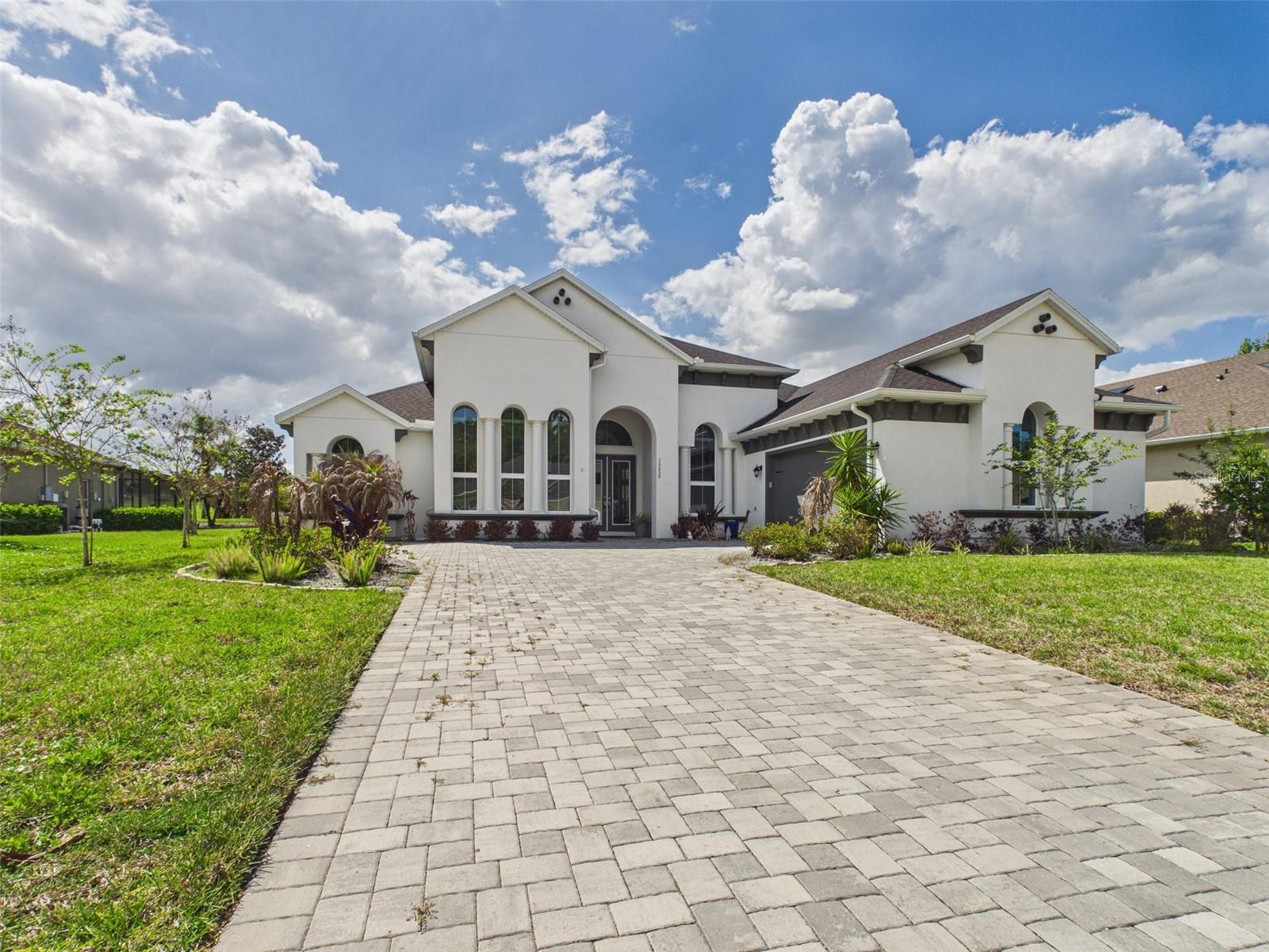 POOL HOME! Experience refined luxury living in the prestigious guard-gated community of Lake Jovita. This exceptional 4-bedroom plus office, 3.5-bath residence plus in-ground swimming pool and 2-car attached garage offers over 3,200 square feet of elegant design and modern comfort. From the moment you enter, soaring 13-foot ceilings and expansive open living spaces create a light-filled, sophisticated atmosphere enhanced by high-end designer finishes throughout. The gourmet kitchen is a chef’s dream, thoughtfully designed with premium features and seamless flow into the spacious great room, highlighted by a striking fireplace wall, custom built-ins, and motorized blinds, perfect for both entertaining and everyday living. The luxurious primary suite is a private retreat featuring tray ceilings, dual walk-in closets, a spa-inspired bath with soaking tub, walk-in shower, and bidet. Step outside to your own private backyard oasis with a screened lanai, sparkling saltwater pool and spa, and lush tropical landscaping: ideal for enjoying Florida living year-round. Additional highlights include an oversized laundry room, two-car garage, and convenient access to major roadways, shopping, dining, and everyday essentials. Seller financing and private financing available. Do not wait, this exceptional home will not last long!