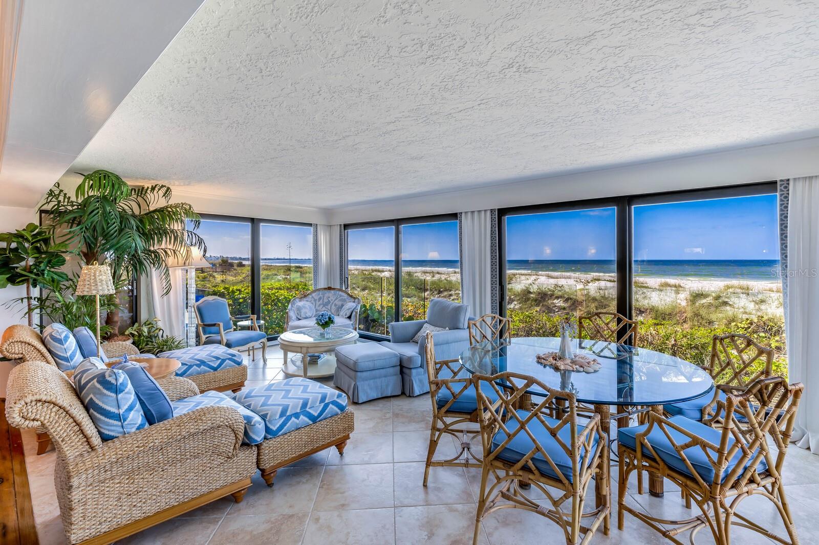 One or more photo(s) has been virtually staged. Escape to your dream beachfront oasis with this stunning end unit at Beach Manor, nestled within the coveted Boca Grande Club—an upscale, gated waterfront community. Revel in the serenity of direct beach access, with this unit perfectly positioned on the sand, offering unparalleled views of the Gulf of Mexico from both inside and the private sundeck.

Enjoy a generous interior, creating a spacious retreat ideal for coastal living. Step outside to the secluded beach, or unwind inside this immaculate 3-bed, 3-bath haven featuring a bright, open floor plan. Renovated in 2018 by Schmehl and Harkness and refreshed by the current owner, discover clear railings for enhanced views, distressed chestnut floors, a gas fireplace, chic wallpaper, Kohler Spa Tub, remote control shades, and hurricane-resistant sliders.

The building itself exudes quality, boasting a new roof, fresh paint, restored concrete, and all-new balconies. Benefit from on-site housekeeping, maintenance, private parking, a nearby pool, and golf cart charging stations. Residents indulge in resort-style amenities, from a top-rated tennis club to a fully-equipped fitness facility. Dine in the exclusive gulf-front clubhouse restaurant, relax at heated swimming pools or the Tiki bar, and savor sunset views.

Seize this rare opportunity to own a slice of paradise on one of the most beautiful and remote stretches of beach. Contact us now to schedule a showing and immerse yourself in the ultimate beachfront lifestyle!