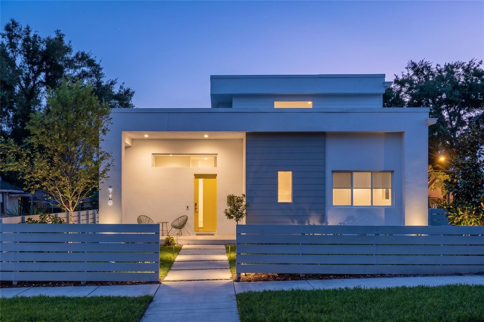Introducing the latest model by MTBH Studios - a striking new contemporary residence at 718 14th Ave S, positioned near downtown St. Petersburg in one of the city’s most exciting emerging growth corridors: the St. Petersburg Innovation District. The city’s recently released master plan for the Innovation District and Marina illustrates a compelling future for this area as a natural extension of downtown and the waterfront. With the recently opened 45,000-square-foot ARK Innovation Center serving as an early anchor in the neighborhood’s evolution as a technology, research, and innovation hub, this location offers a rare opportunity to live where South St. Pete’s continued transformation is already underway. Current planning highlights include mixed-use development, improved waterfront access, boardwalks, trails, public access points, mobility connections, and major infrastructure improvements designed to strengthen the connection between downtown, the waterfront, and South St. Petersburg. Designed for modern urban living, this newly built home blends elevated contemporary architecture, refined MTBH finishes, soaring 12-foot ceilings, and exceptional functionality. A rare first-floor primary suite creates the ease of main-level living while maintaining separation from the additional bedrooms upstairs. The residence features three spacious bedrooms, 2.5 bathrooms, and a dramatic open-concept living area filled with natural light. Expansive windows and sliding glass doors open to a large outdoor deck, creating a seamless connection between the interior living spaces and the private backyard. The kitchen is designed as the centerpiece of the home, featuring sleek cabinetry, premium finishes, an oversized island, and a layout equally suited for everyday living and entertaining. The first-floor primary suite provides privacy and convenience, while the additional bedrooms offer flexibility for guests, family, or a dedicated home office. Built with long-term quality and efficiency in mind, the residence incorporates impact-rated windows and doors, energy-conscious construction, and features designed to meet Florida Green Building Coalition certification standards. Located just minutes from downtown St. Petersburg, the waterfront, major medical and educational institutions, restaurants, arts, entertainment, and the Innovation District, this property offers the opportunity to own a distinctive new-construction home in an area positioned for continued growth.