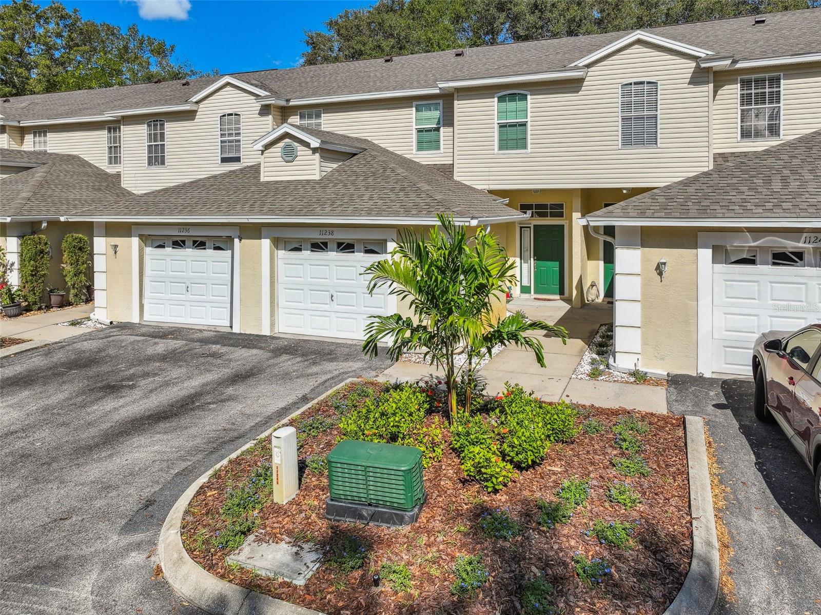 A completely renovated Carrollwood, maintenance free home within walking distance to restaurants and shopping!  The owner of this 3 bedroom, 2 ½ bath townhouse style condominium spared no expense with the beautiful upgrades.  Upon entering, notice the natural light from the window and sliding door to the gorgeous tile flooring. The renovated kitchen is a chef’s dream with slate appliances, an abundance of cabinetry, glass tile backsplash and level 3 granite. The kitchen opens to the dining and great room. A half bath is conveniently located downstairs with a new vanity and fixtures. Second floor has all new hurricane grade windows, new laminate flooring in the bedrooms and hallway and tile flooring in the bathrooms. The oversized primary bedroom has a custom, sliding door opening to the large, walk in closet with custom shelving.  The bath has a walk-in shower with upgraded tile and glass, a new granite countertop, tile flooring and all new fixtures. Two additional bedrooms are located upstairs with an upgraded second bath.  Enjoy a cup of morning coffee on the back patio, your own private, fenced in oasis.  The home has an oversized 1 car garage with extra parking in the driveway, one assigned parking spot plus many guest spaces. Invite friends over and enjoy the quaint, community pool.  Some of the many other upgrades include hurricane shutters for sliding door and window on first floor, hurricane covers for transom and sidelight, all new blinds, painted interior, stained banisters, new baseboards, epoxy garage floor, all new lights and fans, new toilets and MORE!  Washer and dryer convey.  Community installed a new roof in 2020 and recently replaced all landscaping.  This home is close to restaurants, shopping, downtown, Tampa International Airport, expressways and more!