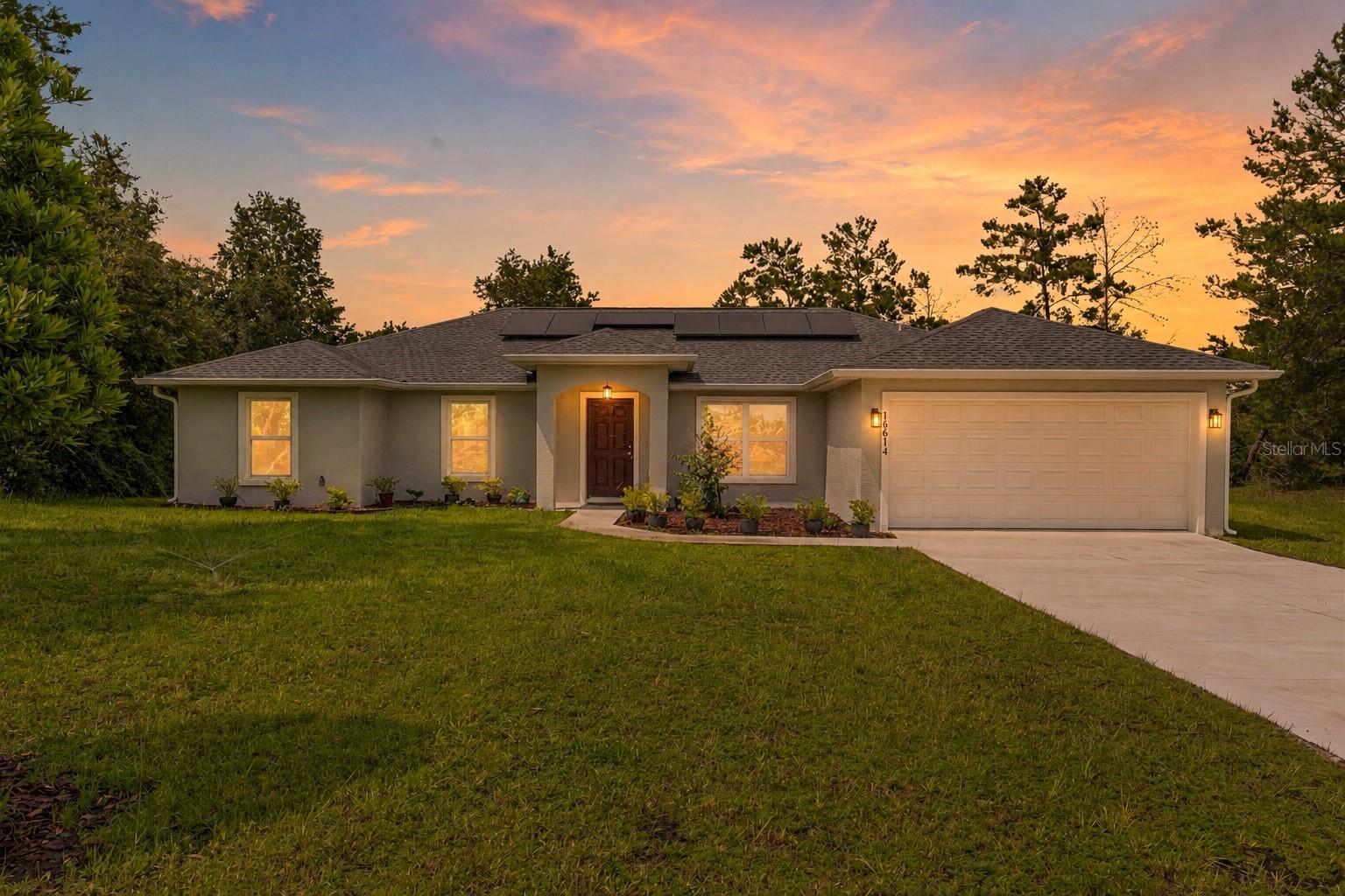 A rare opportunity to own a custom-built home on an oversized .6-acre homesite backing to a former golf course fairway—offering peaceful views, mature trees, and no rear neighbors. Built in 2022, this thoughtfully designed Sanctuary floor plan combines privacy, functionality, and modern finishes. The split-bedroom layout creates ideal separation between the primary suite and guest bedrooms, making everyday living comfortable and convenient. The private owner’s retreat features tray ceilings, a walk-in closet and secondary closet, granite vanity, a spa-inspired walk-in shower, and a barn door primary suite entrance that creates a true retreat feel. On the opposite side of the home, you’ll find three additional bedrooms and two full bathrooms, including a Jack-and-Jill bath. At the heart of the home is a chef-inspired kitchen featuring a gas cooktop, stainless steel appliances, granite countertops, oversized center island, solid wood soft-close cabinetry, pantry, breakfast bar, and wine refrigerator. Vaulted ceilings and abundant natural light flow through the open-concept living area, creating an inviting space for entertaining or everyday living. Step outside to the screened lanai and enjoy your morning coffee while overlooking the former golf course and natural Florida landscape. Additional features include solar panels that provide significant monthly energy savings (buyer must qualify/assume for the transferable solar loan) and a leased propane tank for gas cooktop that will transfer to the new owner.  City Water. If you’re looking for acreage, privacy, no rear neighbors, and a nearly new custom home priced for immediate attention, this is one you won’t want to miss. Schedule a showing today! Video of home: https://youtu.be/SfsDmSqnlUU?is=eqgiPiMr9sYPeH_2