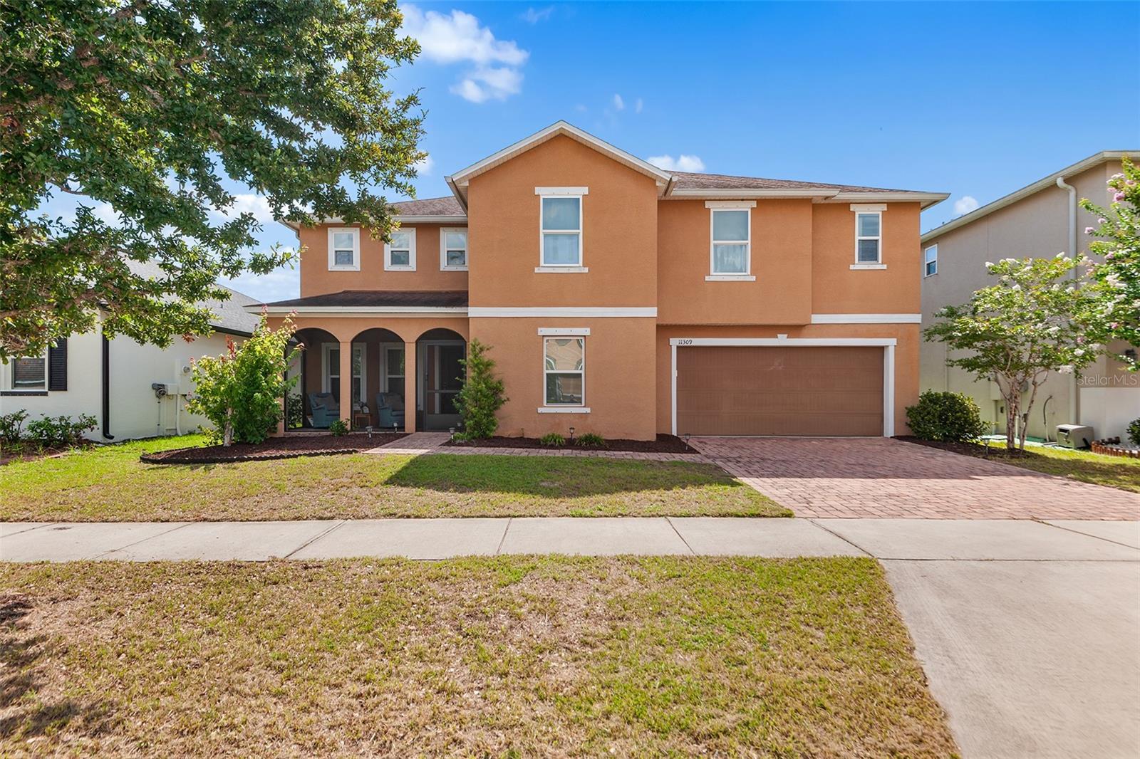 Virtually Staged. Welcome to your new home in the Ibis Cove section of South Fork in Riverview. An impressive 4 bedroom, 2.5 bath two-story home offering over 3,500 square feet with 1 of the largest floor plans in the community. The warm terracotta exterior, arched covered front porch, paver driveway, and attached 2-car garage create outstanding curb appeal. Inside, a bright open layout greets you with tile flooring throughout the main level and an abundance of natural light. Just off the foyer, a versatile flex space adjoins the 5th bedroom, ideal as a home office, gym, playroom, or guest suite. The kitchen impresses with dark espresso recessed-panel cabinetry, granite countertops, a large center island with bar seating, stainless steel appliances, and a walk-in pantry, all opening to a spacious dining area anchored by a globe chandelier and sliding glass doors leading to the backyard, which has room for a large pool. A convenient laundry and mudroom with Samsung washer and dryer sits just off the kitchen with direct garage access, and a half bath rounds out the main floor. Upstairs, a massive loft spanning over 16 by 18 feet serves perfectly as a media room, game room, or second living area. The owner's suite is a standout, measuring nearly 28 by 16 feet with luxury vinyl plank flooring, 2 walk-in closets, and a spa-like en-suite featuring dual vanities with marble-look countertops, a garden tub, frameless glass shower with rain head, and a private water closet. 3 additional bedrooms are well-sized with LVP flooring and share a full bath with granite vanity. South Fork amenities include a resort-style pool, playgrounds, parks, and walking trails, with the CDD fee included in taxes. Conveniently located near top shopping, dining, major commuter routes, and highly rated schools.
