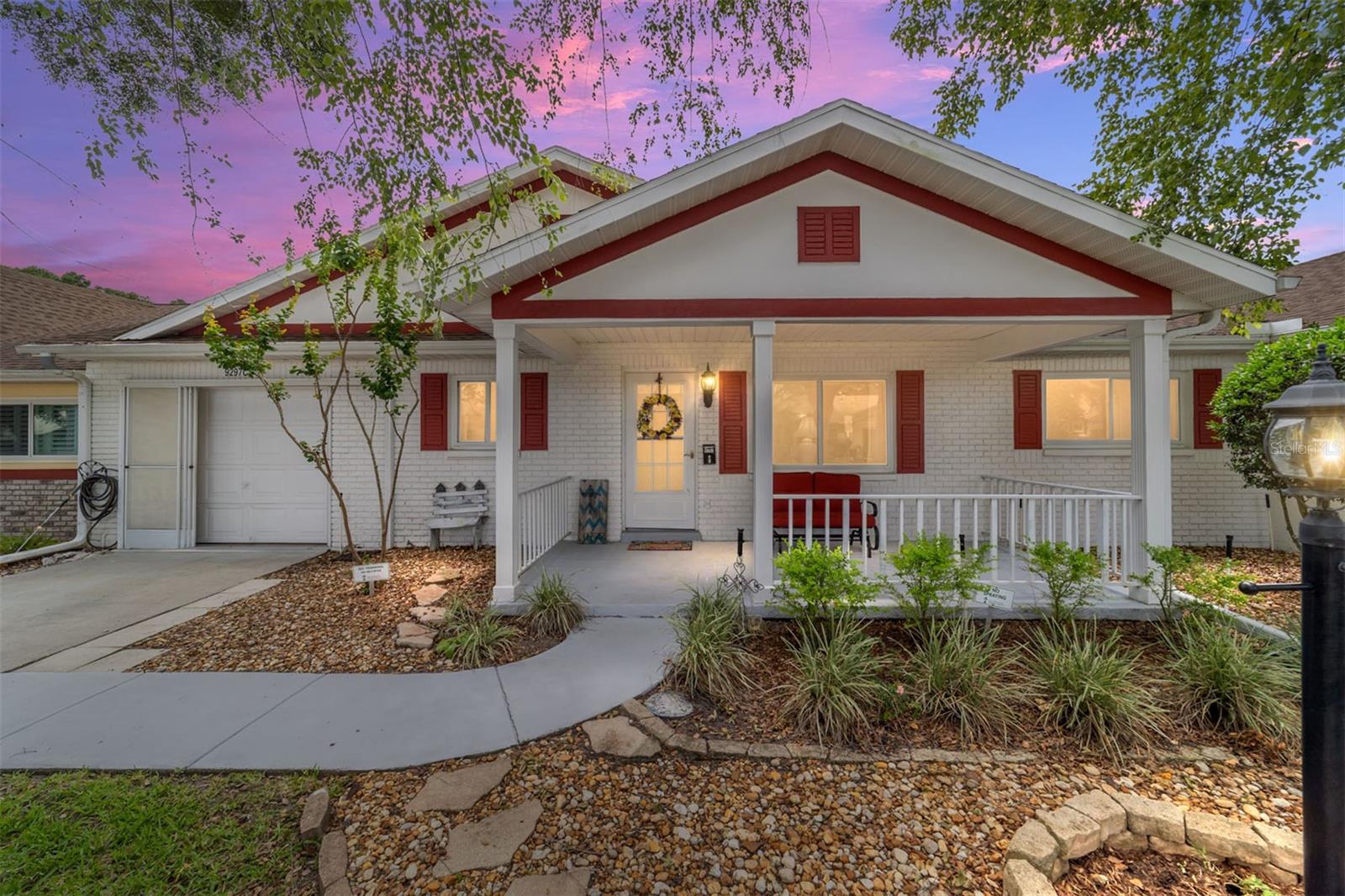 Immaculate and move-in ready, this beautifully maintained 2 bedroom, 2 bath villa offers numerous upgrades and thoughtful custom features throughout. Built with an expanded kitchen and den area not found in many models, the spacious floorplan includes a large great room with dining area, a roomy pantry, and a rare coat closet for added storage. Enjoy newer windows throughout (2021), and stylist gray luxury vinyl flooring throughout the home. The kitchen features a charming chair rail in the breakfast area and unique fandelier fixtures in both the kitchen and dining area. The primary suite offers a walk-in closet, and the wall-mounted TV will remain for the new owner. Relax year round in the spacious carpeted lanai complete with portable A/C, or step outside to the concrete patio for additional outdoor enjoyment. The deep, expanded garage includes the laundry area, a newer washer (5/2026), and a movable modular aluminum ramp. Facing north for comfortable natural light, this exceptional villa has been lovingly maintained by the seller and is truly a rare find.