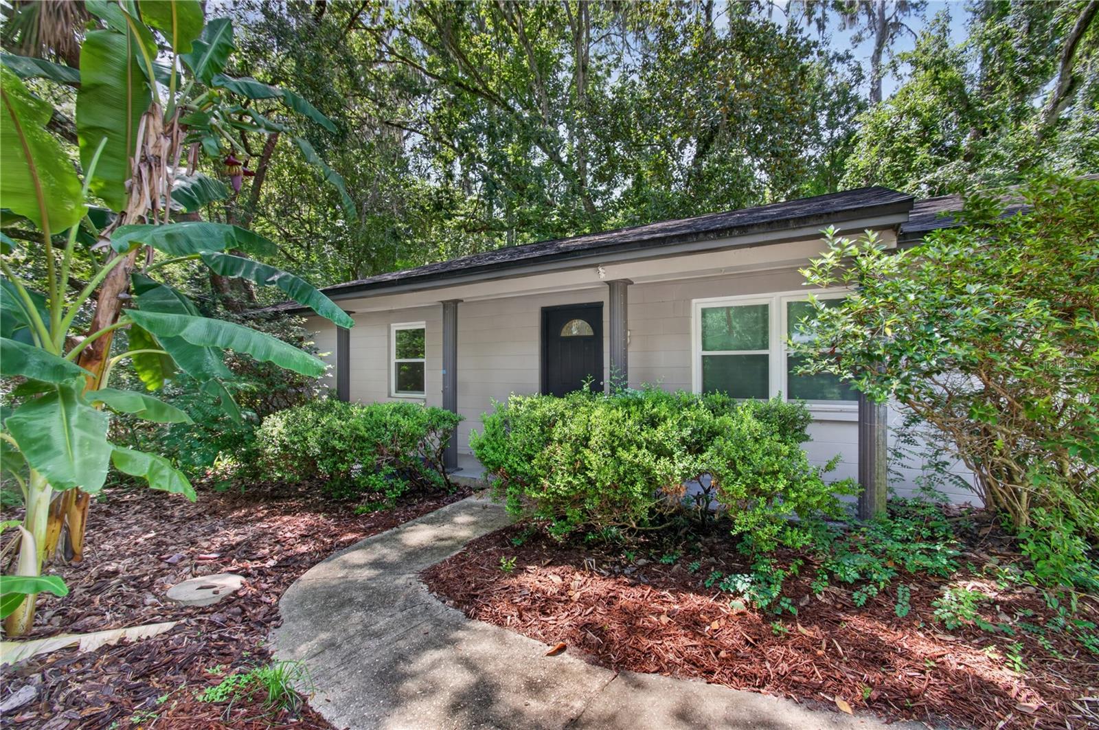 Wonderful and quiet home in NW Gainesville with quick access to NW 13th St and NW 39th Ave, tucked into a quiet cul-de-sac and backing up to mature woods! This charming home just received a new coat of paint inside and outside and became more efficient with a new AC, new windows and doors in 2022. The vinyl plank flooring provides ease of cleaning and with the new paint, a fresh start is awaiting the next owner. The backyard is a natural space fully contained by a wood fence with a divider in case you want to have to plenty of space for a pet separate from a large delicate garden. If you are looking for a centrally located home in a tucked away spot surrounded by trees and nature, this might be the one for you!