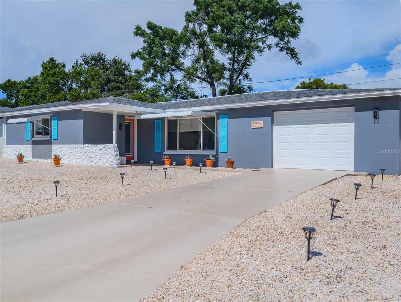 Honey Stope The car ! Mid-Century Modern Charm with Fresh Updates — 2 Bed, 2 Bath (1967 Build) NO FLOOD insurance needed. New windows! Newer roof! Updated Bathrooms !  Step into timeless style with this beautifully maintained mid-century modern home, built in 1967 with solid cement-block construction that stands the test of time. The clean lines, open layout, and natural light create a warm, effortless flow throughout the home.   The heart of the space is the open kitchen overlooking the family room, perfect for entertaining or simply enjoying everyday living. The kitchen features granite countertops, rich wood cabinetry, and a layout that blends function with classic style.  Both bedrooms are comfortable and well-proportioned, and the two full baths offer convenience and privacy. The entire interior has been freshly painted, giving the home a crisp, move-in-ready feel while preserving its mid-century character.   This is the kind of home that blends vintage appeal with modern comfort—solid construction, thoughtful updates, and a layout that just feels good to live in. First time homebuyer and grant programs available for this home.