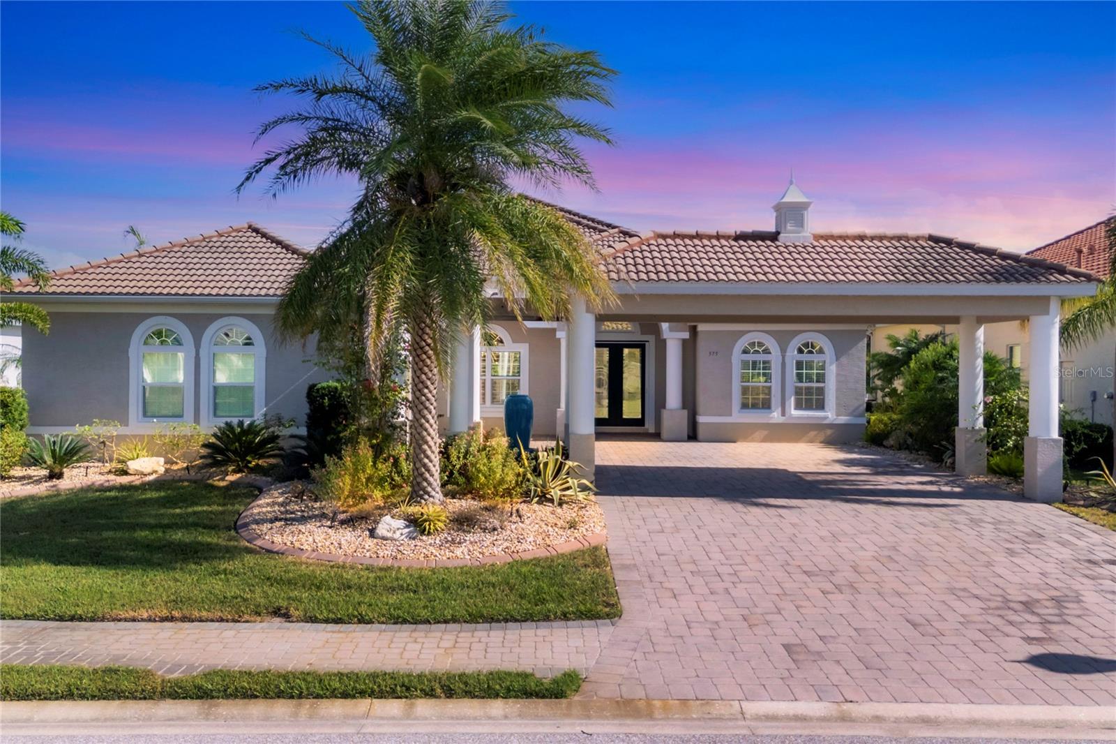 One or more photo(s) has been virtually staged. Sellers said Bring Your Offers... Experience refined coastal living in this exceptional custom-built executive residence located in Harbour Walk, a coveted gated boating community offering resort-style amenities and peace of mind. Move-in ready and thoughtfully designed, this home delivers the very best of Southwest Florida living with direct access to a deep-water canal just minutes from the Gulf of Mexico, pristine beaches, upscale shopping, and fine dining.

Harbour Walk residents enjoy a private marina and dock, tennis courts, playground, and fishing area—perfect for embracing an active coastal lifestyle. The backyard is a true outdoor oasis, featuring over 800 square feet of covered lanai space ideal for entertaining and relaxation. Highlights include a custom outdoor kitchen with island seating, rotisserie grill, dual-zone beverage refrigerator, prep refrigerator, ice bin, and sink; automatic hurricane impact screens; a motorized privacy screen; multiple seating areas; a firepit corner; formal dining space; conversational lounge; freestanding natural gas fireplace; and a pet-friendly yard with a built-in drain.

Inside, more than 3,000 square feet of refined living space showcases an open-concept design enhanced by quadruple sliding glass doors that seamlessly connect indoor and outdoor living. The home offers four bedrooms, including a spacious guest suite, and a luxurious primary retreat with lanai access, dual custom walk-in closets, and a spa-inspired bath with split vanities, garden tub, and walk-in shower. A dedicated executive-style office provides an ideal work-from-home environment.

The chef’s kitchen is beautifully appointed with gas cooking, convection wall oven, warming drawer, exhaust hood, solid wood cabinetry, stone countertops, and a walk-in pantry, complemented by a bright breakfast nook and formal dining room.

Additional features include a resort-style pool and spa with bubbler features, whole-house Generac generator, plumbed natural gas, gas appliances, crown molding, recessed lighting, ceiling fans throughout, hurricane shutters, and a new AC system installed September 2025. The oversized, side-facing two-car garage offers epoxy flooring, additional storage, and a hurricane-rated impact door. Hurricane-impact rated front door, windows, and exterior doors (outside the screened lanai) provide added security and durability.

This one-of-a-kind Harbour Walk residence offers the perfect balance of elegance, comfort, and coastal sophistication—ideal for entertaining, relaxing, and enjoying Florida living at its finest!