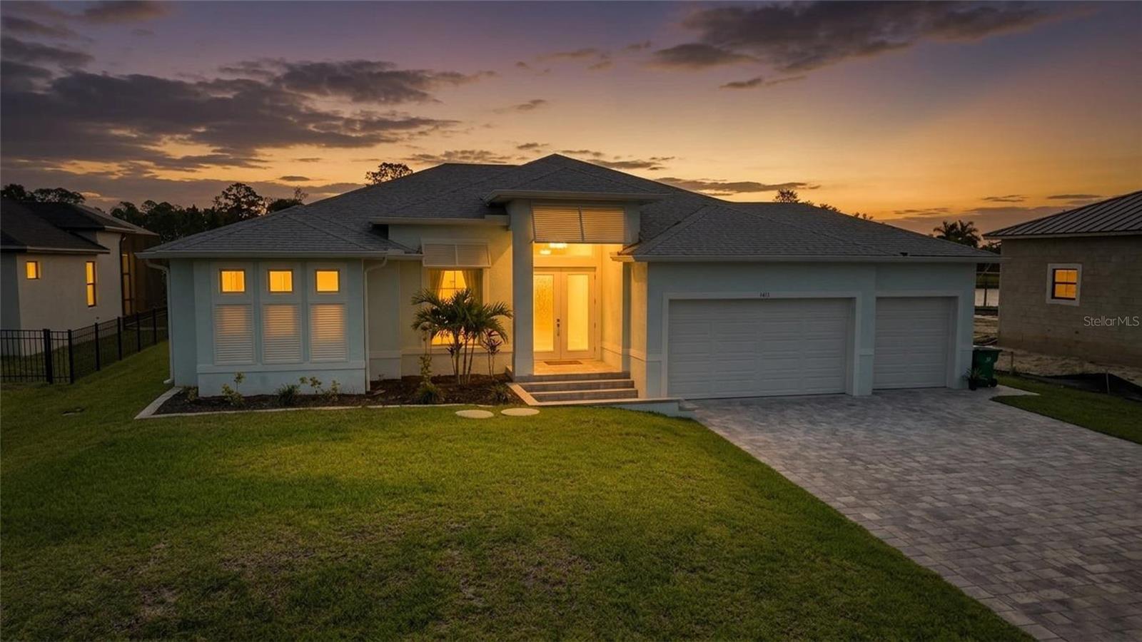 Built in 2024, this 4-bedroom, 2-bath waterfront pool home offers 2,068 square feet of thoughtfully designed living space with an open split-bedroom floor plan, great room, and seamless indoor-outdoor connection. From the moment you step inside, this house feels like home, with coastal-inspired finishes, tile flooring throughout, 12-foot ceilings, a double tray ceiling in the great room reaching 14 feet, and crown molding that adds a refined touch. The kitchen is a standout gathering space, designed with both style and function in mind, featuring stone countertops, wood cabinetry with 42-inch upper cabinets, crown molding on the top cabinets, base cabinet drawers for convenient storage, stainless steel appliances, a range hood, wine refrigerator, pendant lighting, a glass tile backsplash laid in a herringbone pattern, and a center island with seating that opens naturally to the main living area. The 90-degree sliding glass doors bring the indoor and outdoor spaces together, opening the great room to a large covered screened lanai and heated saltwater pool overlooking intersecting canal views, where privacy across the water creates a quiet, peaceful setting for everyday Florida living and entertaining. The large primary suite features pocket sliding glass doors to the pool, two walk-in closets, and a well-appointed ensuite bath with dual vanities and a walk-through shower. Reliable broadband access is already in place through an installed Starlink system. All Starlink equipment will remain with the property, providing a seamless transition for buyers seeking dependable high-speed internet service. Hurricane impact windows and doors, a whole-house reverse osmosis water system, and a 3-car garage with epoxy floors add comfort, function, and peace of mind. Boaters will appreciate the 20-foot Trex composite dock and 10,000 lb. boat lift, with access to the Myakka River and Charlotte Harbor just minutes away. With no HOA or CDD and a location close to shopping, dining, and entertainment, this Port Charlotte home delivers new construction, waterfront living, privacy, and practical long-term appeal in one inviting package.