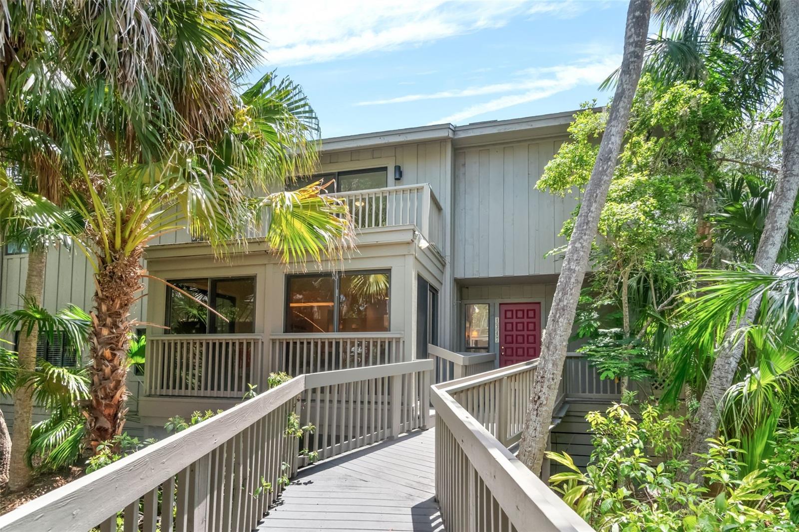 Nestled among lush tropical foliage in the highly sought-after Landings community, this one-of-a-kind treehouse retreat offers the perfect blend of nature, light, and waterfront living. Ideally positioned along the scenic boardwalk near Sarasota Bay, this spacious residence is filled with sunshine and tranquil views from nearly every room.


The first floor is wrapped in walls of glass, creating an airy indoor-outdoor feel and showcasing peaceful water and garden vistas. A versatile flex space offers endless possibilities as a large home office, family room, fitness studio, or creative retreat. The open kitchen features a generous dining area surrounded by windows, making every meal feel connected to the beauty of nature.


Generously sized rooms throughout the home, including all bedrooms, provide comfort and flexibility for everyday living and entertaining. Just steps away, enjoy the community pool or stroll along the winding nature path through mature tropical landscaping to the bayfront gazebo — the perfect setting for spectacular sunsets and watching dolphins play in the water.


Residents enjoy easy access to downtown Sarasota, world-famous beaches, exceptional dining, and shopping. Optional membership to the Landings Racquet Club offers resort-style amenities including a super sized pool, tennis and pickleball courts, fitness center, library, and welcoming social spaces to connect with neighbors and friends.