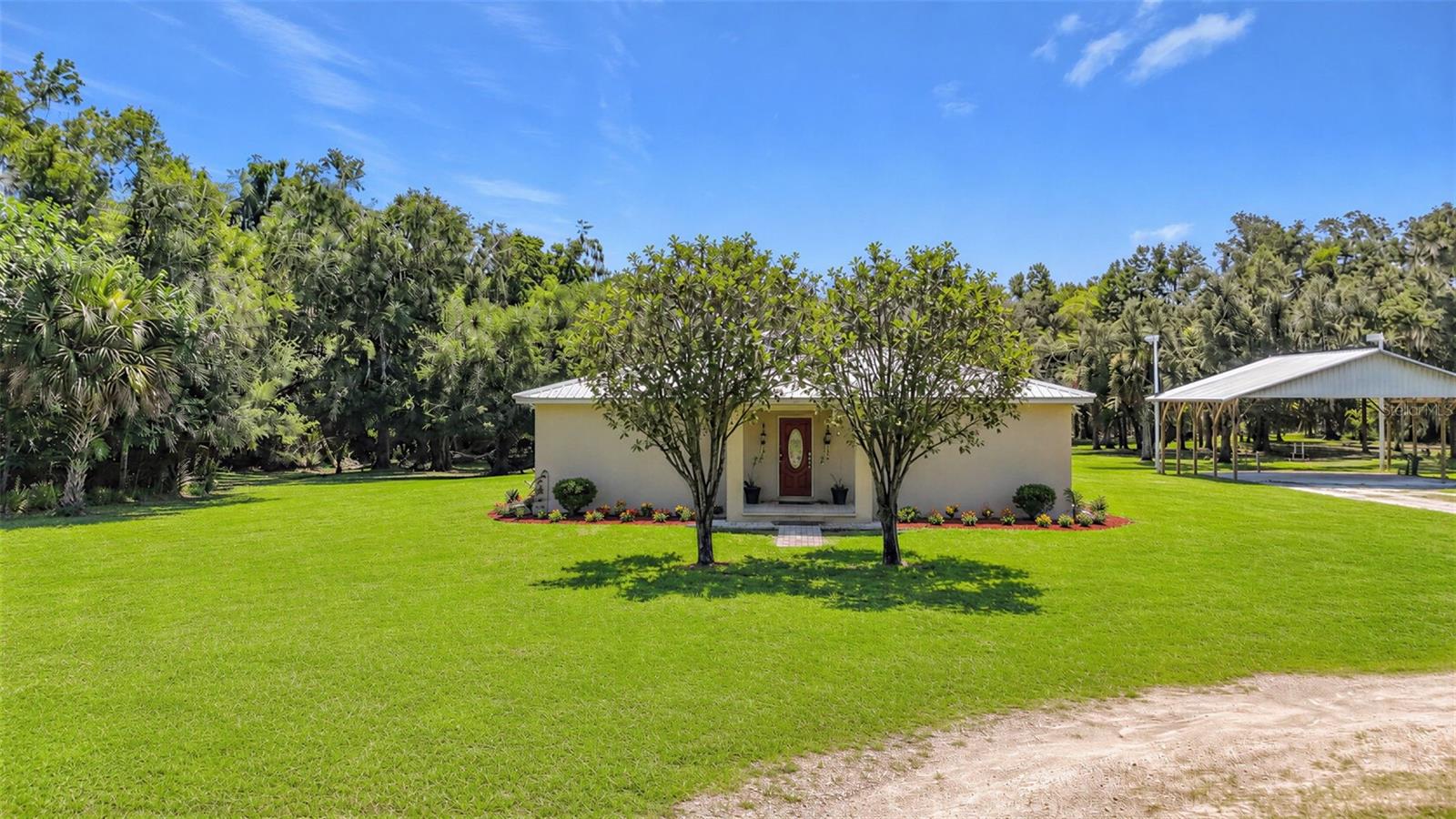 Virtually Staged. ATTENTION BUYERS This is not your average SFH. Positioned across TWO separate, buildable parcels you can escape to your own 2.46-acre self-sufficient paradise in Wauchula, completely free from crazy HOA rules. Property has primary 3/2 home and a 32x40 heavy-duty pole barn, independent operational water wells, and full homestead-ready setups. This solid, 2 owner custom-built 3-bedroom, 2-bathroom sanctuary perfectly balances high-quality craftsmanship, homesteading freedom, and family-friendly outdoor adventures. Park your toys, bring your animals, and live completely on your own terms. Home has 3 separate wells and 2 septic. Garden ready and chicken friendly with coop in place to harvest your own fresh eggs. Property spans two separate parcels, allowing rehab of current other structure for use as workshop or home or tear down and rebuild on second lot.  Sellers do not have all info on building options. Buyers interested in using second building for more than a shed or HOZ will have to work with Hardee Co. to review plans on their own.  Bonus features include a massive 32x40 pole barn. Superior Custom Construction built in 2006 with a level of structural integrity that easily out stages 2020-era track home builder models right down to having a radiant barrier in the attic for lower energy costs. Generous Layout Features 2,524 total sq ft under roof with 1,753 sq ft of air-conditioned living space. Sun-Drenched Rooms lift up to vaulted ceilings and an open-concept floor plan flooded with natural and lots of recessed lighting. Updated beautifully with granite countertops, quality cabinetry, and newer tile and luxury vinyl plank flooring throughout. Designed with split-plan bedrooms and a master bath featuring dual sinks and separate his-and-hers closets. Massive laundry room connects to an 8x12 bonus room, perfect for a super-sized pantry or homestead prep room. Backyard bliss & outdoor adventure await the whole family. Keep kids entertained for hours with play area featuring a zipline and classic tire swing. Adults unwind under the shade of mature trees in cozy hammock positioned to spot deer, turkeys and rabbits roaming across vast green spaces just steps away from oversized covered and screened in back porch with additional open wooden deck complete with country style 2 seat swing. Home is surrounded 3 nature reserves where the Peace River intertwines for fossil hunting, kayaking, and canoeing. For more active options there are city tennis and pickleball courts located just minutes away. This two-owner hidden gem offers city dwellers the ultimate modern-rustic escape with all the infrastructure already in place.  This estate offers a level of long-term value, durability, and financial upside that basic neighborhood properties simply CANNOT match.