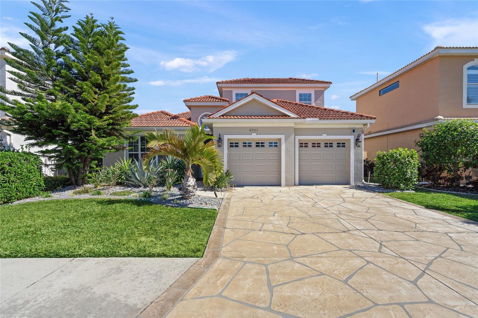 Welcome to your private tropical retreat in the highly sought-after Tara Preserve community. This beautifully maintained 4-bedroom, 3-bath, 2-car garage, two-story pool home offers serene lake views, no rear neighbors and a peaceful setting surrounded by mature landscaping—all with LOW HOA fees and NO flood zone. Inside, the home features an open-concept layout with soaring ceilings, tile and laminate flooring throughout and both formal living and dining areas. The spacious family room opens through sliding glass doors to the oversized screened pool lanai, creating the perfect indoor-outdoor living experience. The well-appointed kitchen is ideal for entertaining, showcasing stainless steel appliances, granite countertops, natural wood cabinetry, tile backsplash, a breakfast bar, a large pantry and a separate eat-in area. The primary suite is conveniently located on the first floor, complete with a walk-in closet and an en suite bath featuring dual vanities, a walk-in shower and a relaxing garden tub. Two additional bedrooms and a shared full bath are also on the main level. Upstairs, a private fourth bedroom with its own bathroom offers an ideal guest suite or flexible living space. Step outside and enjoy the expansive screened pool area—perfect for relaxing, entertaining or summer gatherings in total privacy. Tara Preserve is a desirable golf course community with no mandatory membership and offers outstanding amenities including tennis and pickleball courts, clubhouse, heated pool and spa, internet and cable for up to three TVs. Centrally located near shopping, dining, schools and major roadways. This exceptional home combines comfort, privacy and resort-style living—schedule your private showing today!