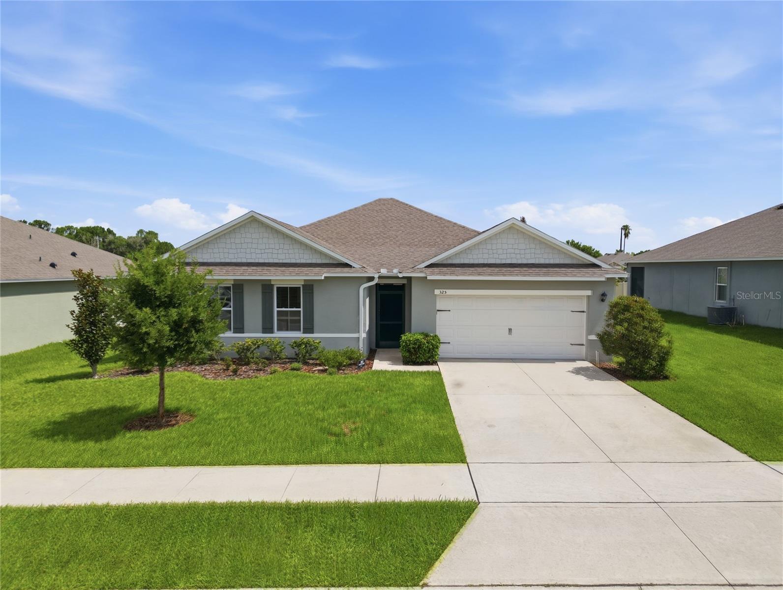 Welcome home to Auburn Grove! Built in December of 2021, this beautifully maintained 4-bedroom, 2-bath home offers over 2,400 square feet of thoughtfully designed living space on an oversized lot with one of the larger backyards in the community.

Step inside to an open-concept floor plan where the spacious living room, dining area, and designer kitchen flow seamlessly together—perfect for entertaining or everyday living. The kitchen has been tastefully updated with new granite countertops, a modern sink, stylish backsplash, and an oversized center island with seating, creating the ideal gathering place for family and friends.

Throughout the home you’ll find new wood-look tile flooring and fresh premium interior paint, giving the home a clean, modern feel that’s move-in ready.

The split-bedroom layout provides privacy, while the generous primary suite features a large walk-in closet and an ensuite bath complete with dual vanities, a garden tub, and separate shower. Three additional bedrooms offer flexibility for guests, a home office, or growing families.

Enjoy Florida living year-round from the screened front entry or unwind on the screened rear lanai overlooking the expansive fenced backyard—offering plenty of room for pets, play, or even a future pool.

Additional features include a 2-car garage, indoor laundry room, and a community pool for residents to enjoy.

Conveniently located near shopping, dining, schools, and major highways, this home combines modern updates, functional living space, and a fantastic location. Schedule your private showing today!