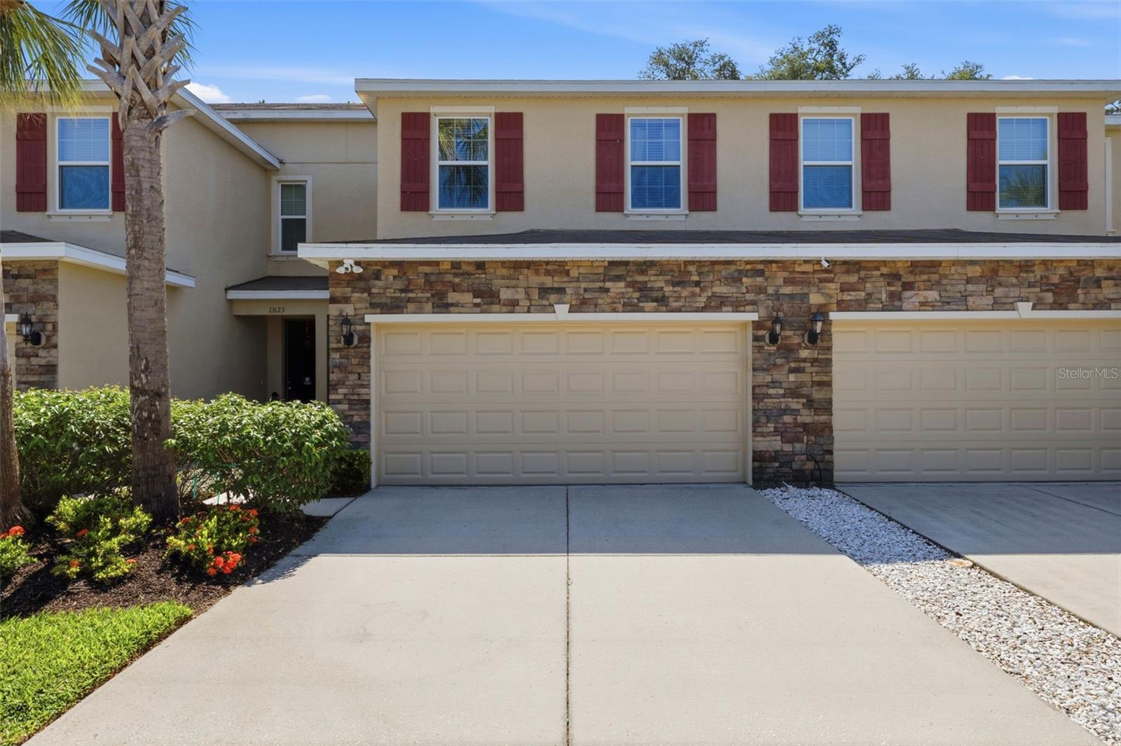 Welcome to the Creeks of Citrus Park a hidden gem offering the perfect blend of tranquility, functionality and style. Featuring a lovely townhome with 3 bedrooms, 2.5 baths, a unique elevation with stacked stone, a screened lanai with stunning views of tranquil back yard, plus a 2-car garage. Stroll up the walkway passed the quaintly landscaped front yard to the entrance of the home. There is a seamless flow from the foyer, dining room and living room to the kitchen creating an ideal environment for entertaining and everyday living. Living and dining room boast neutral colors, chair rail, tile flooring , custom chandelier, ceiling fan with lights, slider to lanai and volume ceilings. Downstairs half bath includes granite counters, wood cabinetry and designer light fixtures. Excellent- sized kitchen features wood cabinetry, granite counters, island with 3 custom pin lights, closet pantry, all appliances including, refrigerator, cooktop range and oven, microwave above, dishwasher,  plant shelves, large eat-in nook with designer light fixture and tile flooring.  Sweeping stairs complete with newer luxury vinyl plank flooring lead to the  upper level  thoughtfully designed with the spacious primary suite offering luxury vinyl plank flooring, large walk-in closet  an neutral colors. Master bath hosts dual vanity, granite counters, wood cabinetry, designer fixtures, expansive shower stall with designer listello tile and glass enclosure plus a linen closet. Two additional bedrooms and bath complete the upper level as well as the inside laundry room which is complete with the washer and dryer. The quaint covered, screened lanai  provides a private haven and overlooks lush plantings and landscape. Notables include water softner system which conveys, 2-car garage with upper , attached storage shelves, automatic opener for convenience, hurricane shutters, no carpet, newer luxury vinyl plank flooring in upper level, tile flooring throughout lower level , all appliances convey, neutral colors and turn-key condition. Superb location with excellent shopping, schools, entertainment and professional services. Easy access to the airport, beaches & interstate. Home has been impeccably maintained and is ready for its new owners. An absolute Must See !!!