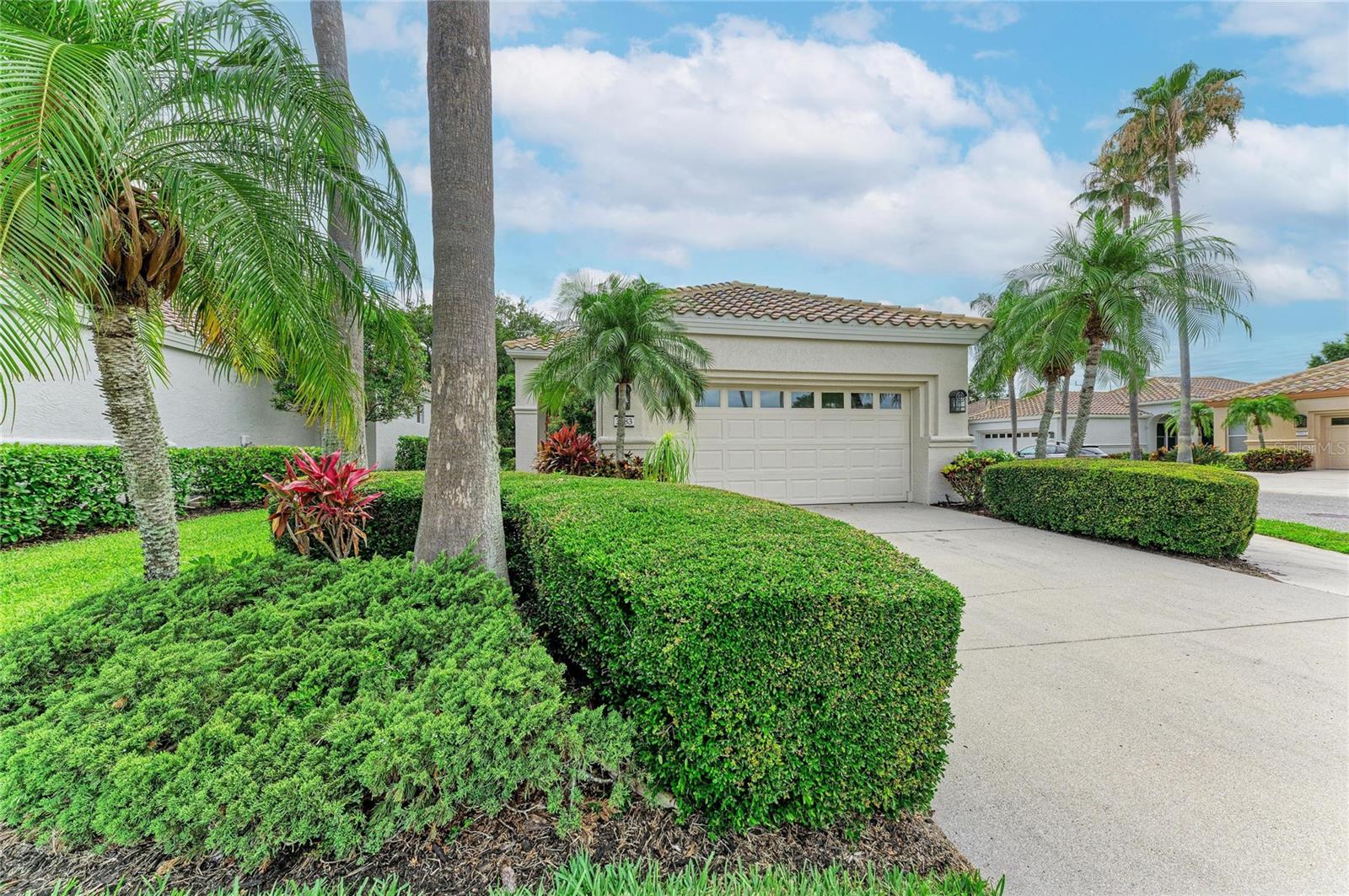 Welcome to Mira Lago of Palmer Ranch, a pristine community with mature landscaping and sidewalks throughout conveniently located minutes from Siesta Key. This corner lot home has no through traffic and features a peek-a-boo view of a serene lake with bountiful wildlife.  This home offers plenty of updates including A/C (2021), barrel tile roof (2022), exterior paint (2025) and a newer water heater. The community provides maintenance free living including lawn landscaping, irrigation, mulch, pest control, roof cleaning, driveway and sidewalk power washing, and basic Frontier cable allowing you the time to explore what Sarasota has to offer. Walk into the main living area to find 12 foot vaulted ceilings with crown molding throughout. The floors in the main area as well as both bedrooms have been recently updated with beautiful luxury vinyl flooring and the windows are highlighted with plantation shutters.  Additional walls and build-ins have been added for esthetics and flow giving this floor plan a unique look in comparison to others in the community.  Hurricane shutters have been added for extra protection from looming storms.  The community offers a pool and spa to relax by when you are finished enjoying Sarasota's world-class dining, beaches, entertainment or simply strolling down Legacy Trail which has trail heads conveniently located nearby.  Experience all Sarasota has to offer while nestled safely in your own private gated community.