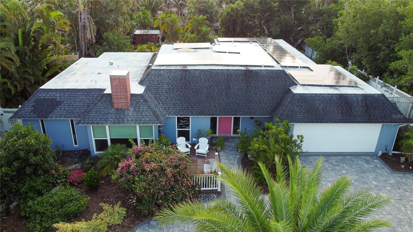 Experience the best of waterfront island living in this exceptional 4-bedroom, 2.5-bath residence, perfectly positioned just minutes from the world-famous shores of Siesta Key Beach. Situated on a sprawling corner lot of approximately 22,000 square feet — with 80 feet of canal frontage — the property is enveloped by mature tropical landscaping that creates an incredibly private, resort-like sanctuary you have to see to believe.

This home has been completely and thoughtfully updated — truly move-in ready with select furnishings included. New hurricane impact-rated windows and sliding doors (2023) provide both security and peace of mind, while the Tesla Solar System with battery backup delivers energy efficiency and independence.

Step outside and discover your own private paradise. A tiki hut, freeform pool with cascading waterfall, and stunning outdoor living spaces make entertaining effortless, while your private dock with boat lift puts boating, fishing, kayaking, and paddleboarding right at your doorstep. The sheer size and lush privacy of this lot is a rare find — expansive, tranquil, and beautifully landscaped.

No HOA. Just freedom, flexibility, and the Florida lifestyle at its absolute finest — minutes from the boutique shops, acclaimed dining, and laid-back charm of Siesta Key Village.