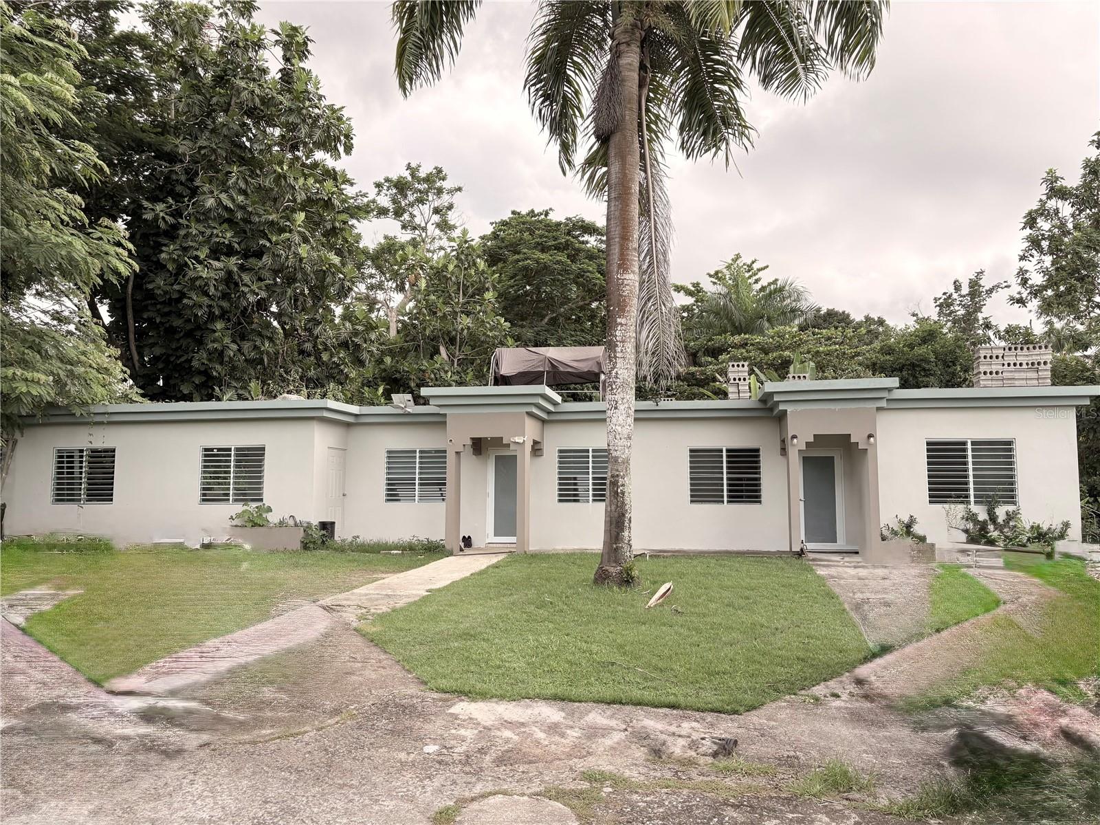 Prime investment opportunity in Carolina! This property sits on 1.5 cuerdas (1.46 acres / 5,895 sq ft) and features two strategically divided structures with 6 residential units, currently generating steady rental income. Perfect for investors seeking high ROI or families looking for space and versatility. Includes a solar panel system, large green areas, ample parking, and is located on a quiet cul-de-sac for privacy and security. Well-maintained, income-producing, and move-in ready—don’t miss this rare chance to own a profitable and versatile property in a prime Carolina location!
