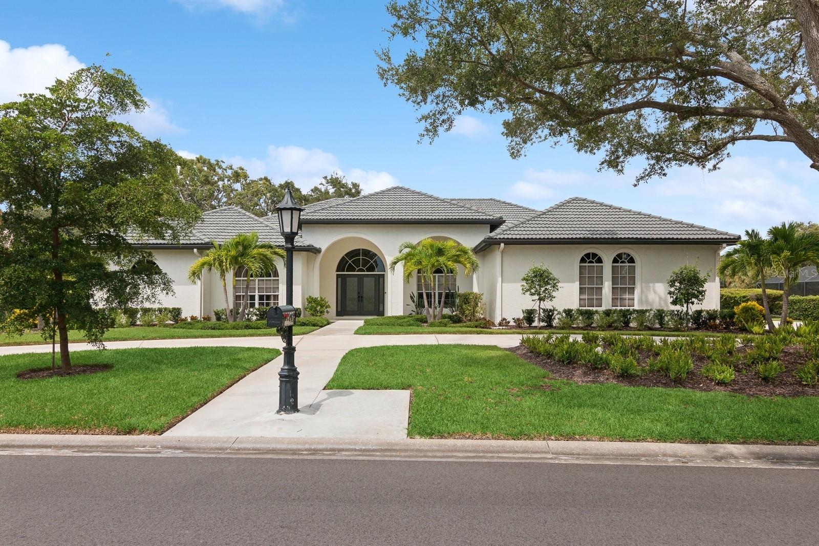 Situated on a tree-lined street within the upscaled gated community of Prestancia, in Palmer Ranch, this home backs onto a private lake along the 16th fairway of TPC Players Course, an International Audubon Golf Sanctuary, part of the esteemed global TPC Network of Clubs and Heritage Golf Group Collection of Clubs.

Custom designed and built, this home maximizes Florida’s natural beauty with ample windows. It blends indoor and outdoor spaces, allowing views, breezes, and sunlight to be part of the living experience. The Modern Universal Design interior layout, from 2021-2024, combines a laid-back coastal vibe with elegant boutique touches. The open-concept design is perfect for both relaxation and entertaining, featuring new walls, doors, flooring, electrical, lighting, and plumbing fixtures.

The owner’s wing offers a luxurious bedroom suite with a spa-like bath featuring a soaking tub, zero-entry shower, dual sinks, custom cabinetry with accent lighting, a dressing room, and ensuite laundry—a true sanctuary for comfort and accessibility.

The guest wing includes three spacious bedrooms, each with ensuite bathrooms and walk-in closets. Two offices feature large arched windows, built-in cabinets, and antique wood doors worthy of a décor magazine. The open kitchen integrates dining, living, and outdoor spaces, featuring an oversized island with seating for six, Maplewood cabinetry, gray quartzite countertops, and luxury appliances for a curated blend of Kentucky craftsmanship and European design. The pantry offers ample storage with deep drawers and shelves.

Luxury epoxy flooring enhances the foyer, while the living and dining rooms flow seamlessly to the outdoor space, where a redesigned pool, heated spa, and new protective cage overlook the serene golf course, ensuring privacy.

New exterior landscaping with native plants, fresh sod, and majestic live oaks provides low-maintenance ecological benefits. The three-car garage and parking for 10 vehicles make it perfect for hosting. Brand new roof, new HVAC system installed.

This property is centrally located near Siesta Beach, downtown Sarasota, Sarasota Airport, Sarasota Memorial Hospital, and local amenities like shopping, dining, and the Legacy Bike Trail.

Schedule your private showing today!