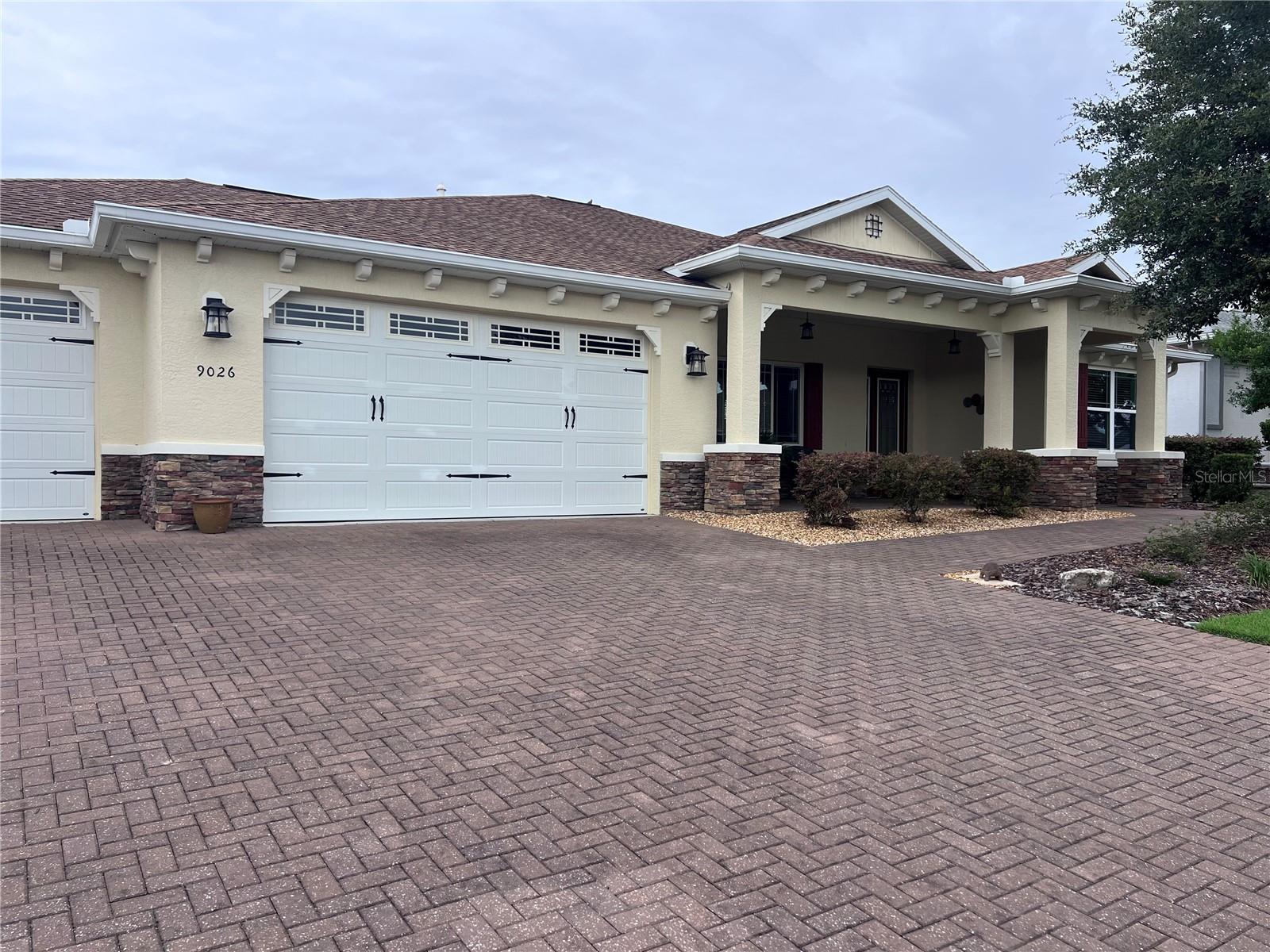 Welcome to this beautifully upgraded Brighton Model located in the highly sought-after Sanctuary at Candler Hills West within On Top of the World. This spacious home features 2 bedrooms, 2 bathrooms, a versatile flex room, and an oversized 3.5-car garage offering exceptional storage space for vehicles, golf carts, hobbies, or a workshop.

The open-concept floor plan is filled with natural light and seamlessly connects the living room, dining area, and kitchen, creating an ideal space for everyday living and entertaining. Elegant crown molding enhances the main living areas, while tray ceilings in both the living room and primary suite add architectural detail and a spacious feel. The split-bedroom layout provides privacy for guests, while the flex room can serve as a home office, den, hobby room, or potential third bedroom.

The gourmet kitchen showcases granite countertops, a large center island with ceramic sink, staggered maple cabinetry with crown molding, designer glass tile backsplash, and under-cabinet lighting. Tile flooring laid on the diagonal flows throughout the main living areas, with luxury vinyl plank flooring in both bedrooms for added comfort and durability.

Additional upgrades include a whole-house water filtration system, gutters, a paver driveway, and an extended paver area outside the lanai. The laundry room is equipped with a convenient utility sink. The large, enclosed lanai provides additional living and entertaining space, perfect for enjoying Florida's year-round lifestyle.

Situated on a desirable lot in one of Ocala's premier 55+ communities, this home combines thoughtful upgrades, functional living space, and an exceptional 3.5-car garage rarely found in similar homes.