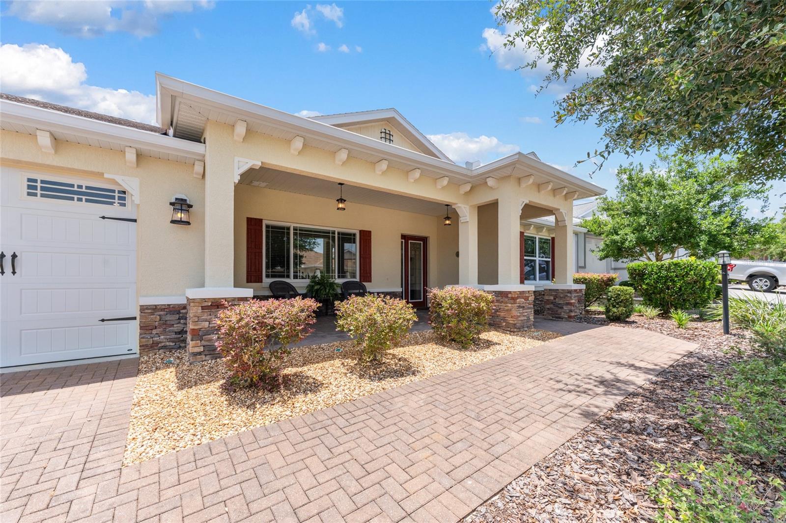 Welcome to this beautifully upgraded Brighton Model located in the highly sought-after Sanctuary at Candler Hills West within On Top of the World. This spacious home features 2 bedrooms, 2 bathrooms, a versatile flex room, and an oversized 3.5-car garage offering exceptional storage space for vehicles, golf carts, hobbies, or a workshop.

The open-concept floor plan is filled with natural light and seamlessly connects the living room, dining area, and kitchen, creating an ideal space for everyday living and entertaining. Elegant crown molding enhances the main living areas, while tray ceilings in both the living room and primary suite add architectural detail and a spacious feel. The split-bedroom layout provides privacy for guests, while the flex room can serve as a home office, den, hobby room, or potential third bedroom.

The gourmet kitchen showcases granite countertops, a large center island with ceramic sink, staggered maple cabinetry with crown molding, designer glass tile backsplash, and under-cabinet lighting. Tile flooring laid on the diagonal flows throughout the main living areas, with luxury vinyl plank flooring in both bedrooms for added comfort and durability.

Additional upgrades include a whole-house water filtration system, gutters, a paver driveway, and an extended paver area outside the lanai. The laundry room is equipped with a convenient utility sink. The large, enclosed lanai provides additional living and entertaining space, perfect for enjoying Florida's year-round lifestyle.

Situated on a desirable lot in one of Ocala's premier 55+ communities, this home combines thoughtful upgrades, functional living space, and an exceptional 3.5-car garage rarely found in similar homes.